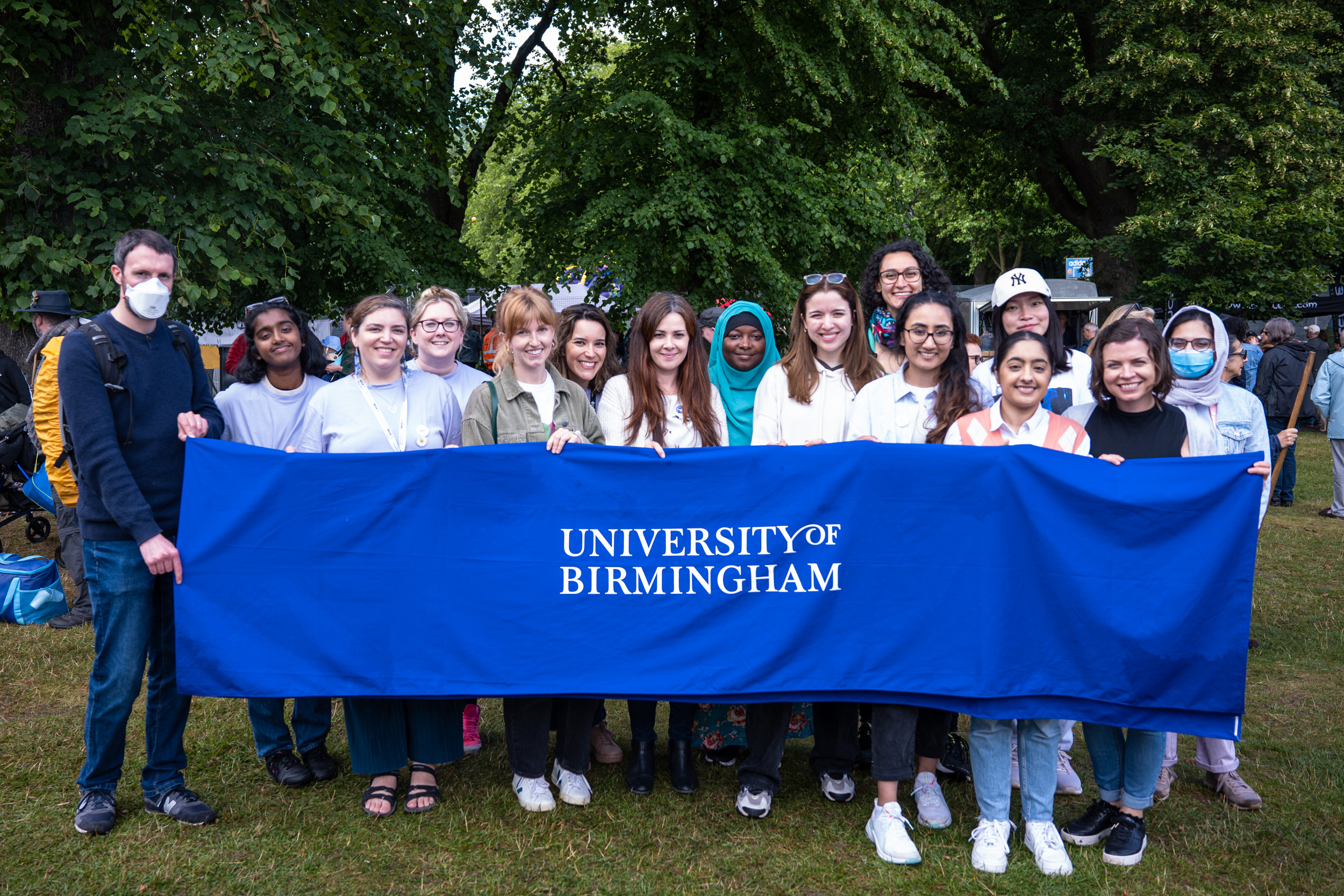 Outreach staff standing behind a University of Birmingham banner