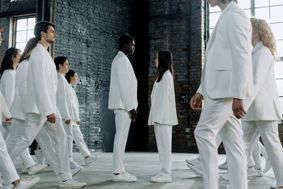 Group of People in White Clothes facing each other