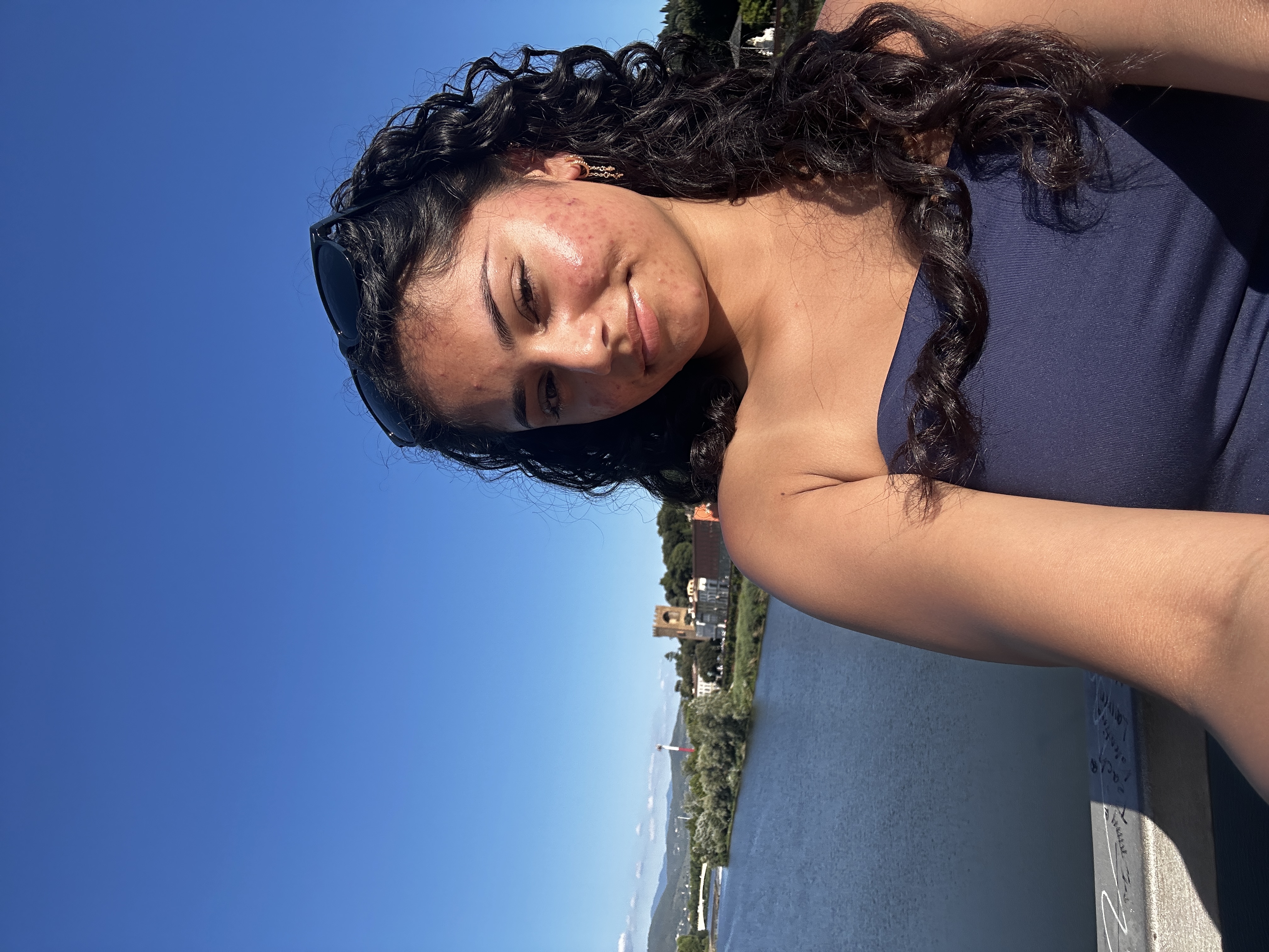 Woman taking a selfie by a lake.