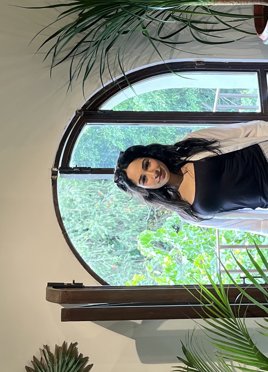 Diya standing in front of an open window smiling