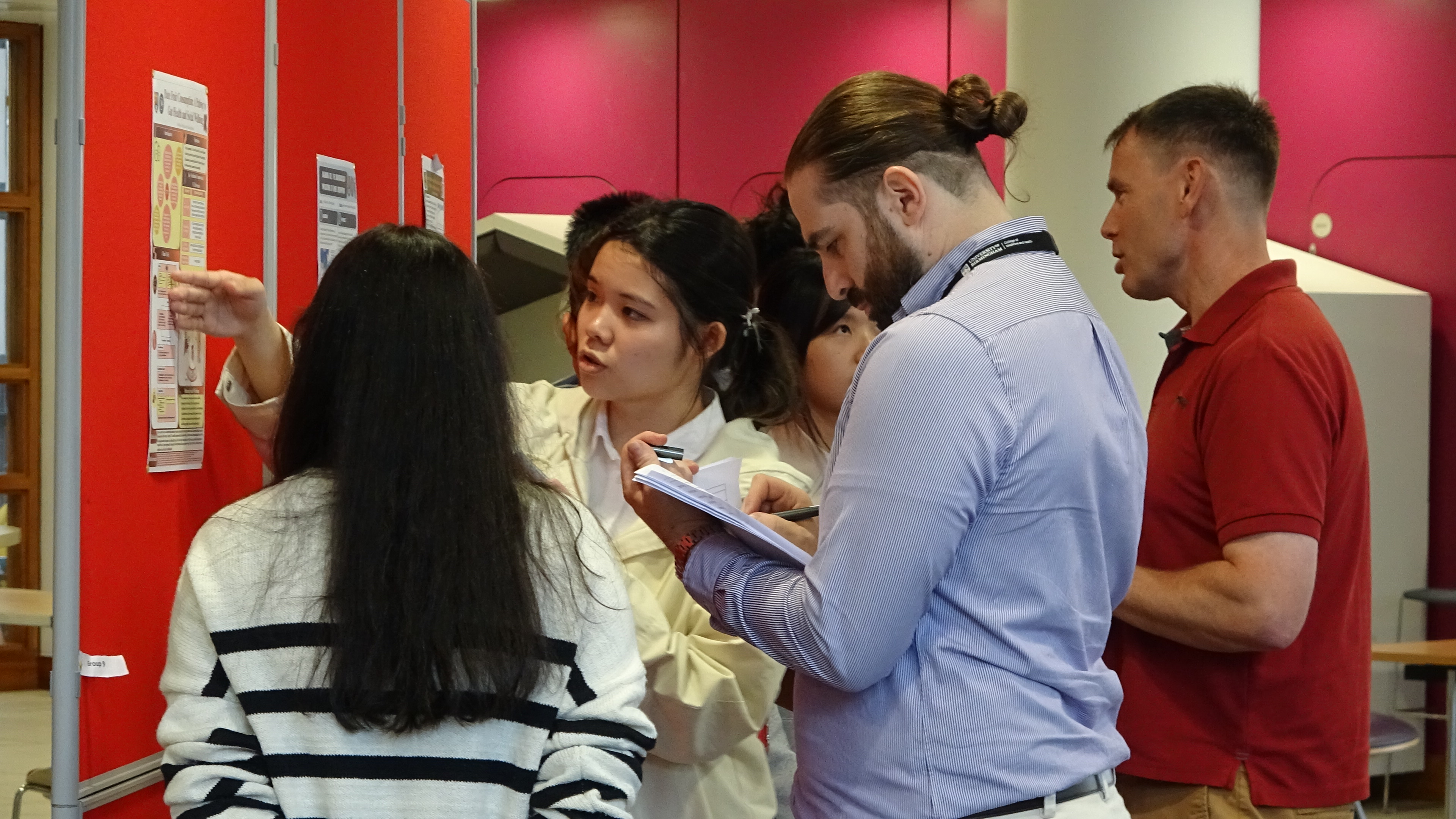 a student presenting her article to the group of academics