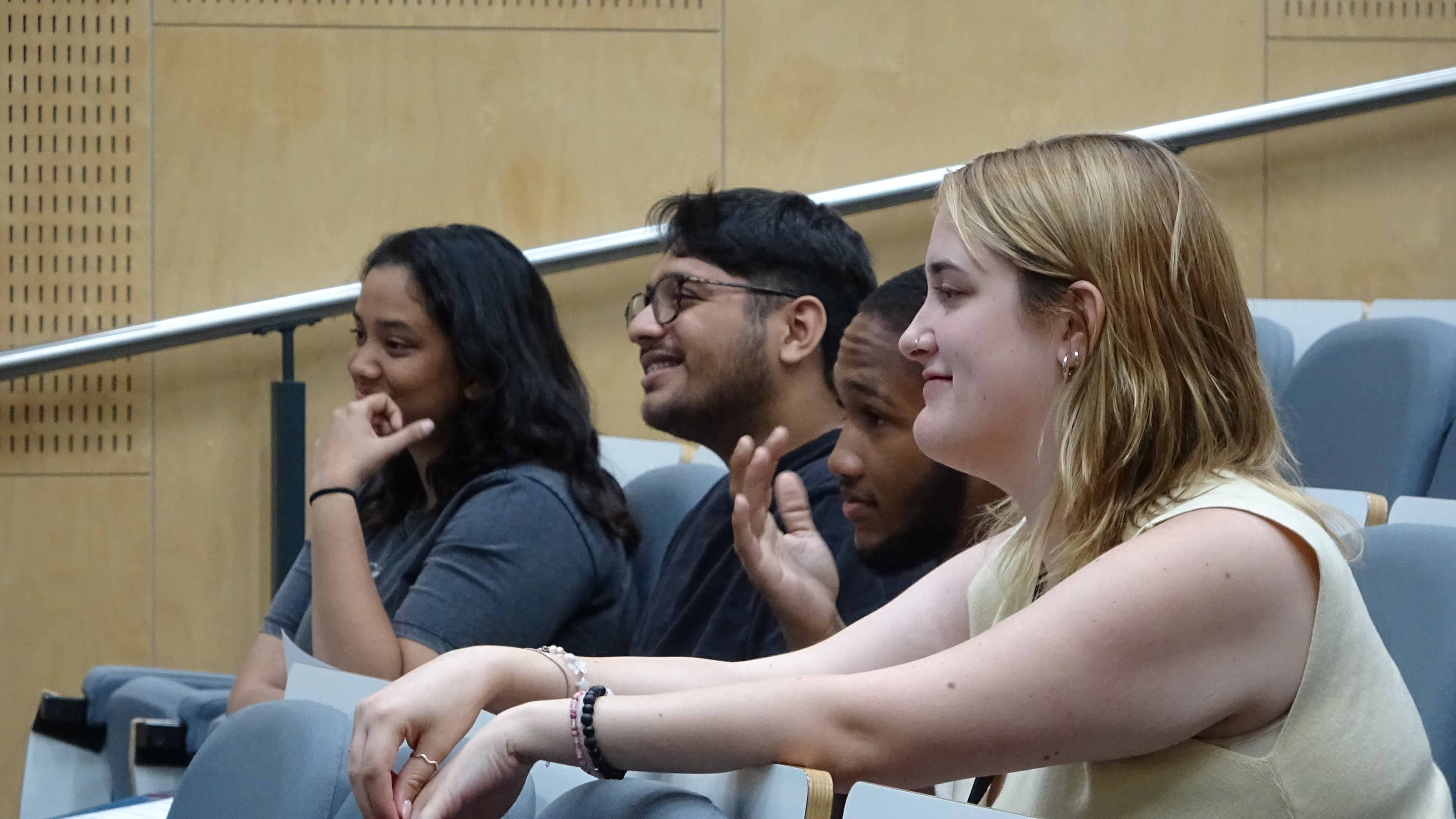 group of students smiling during an ongoing lecture