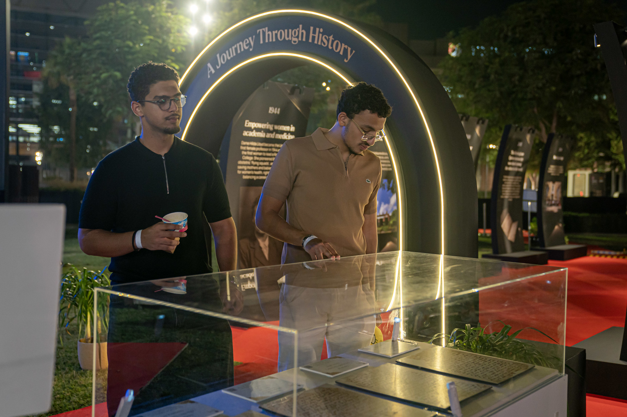 Students explore a history walk display of the University of Birmingham’s 125‑year journey.