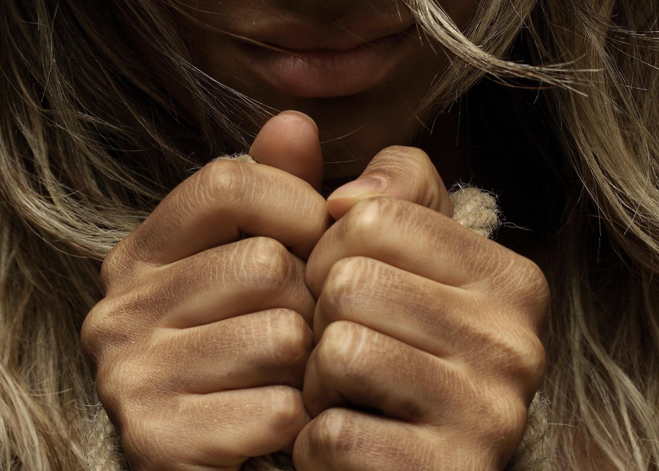 Close-up of woman with bound hands