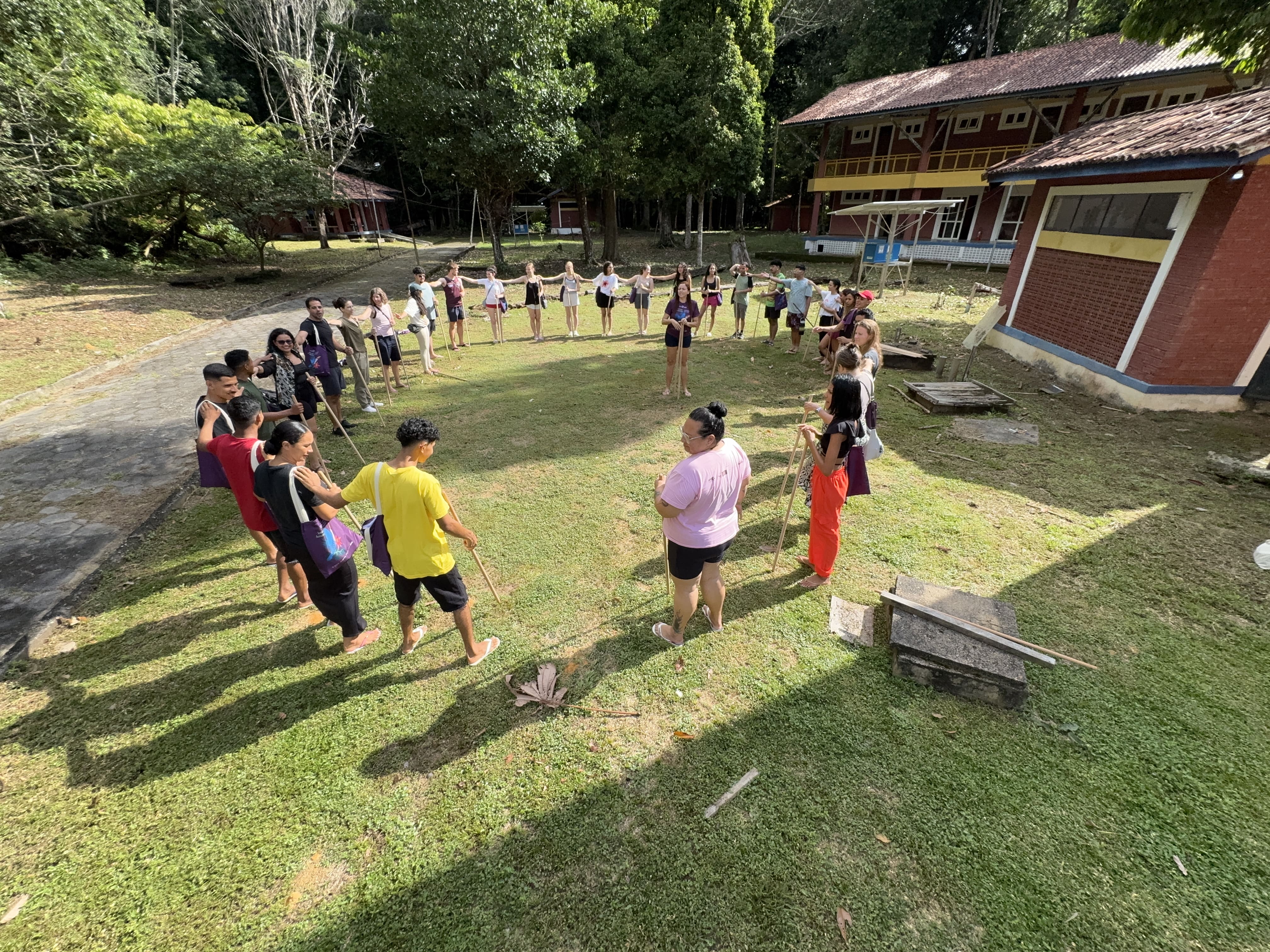 Immerse students and staff standing in a circle playing a game