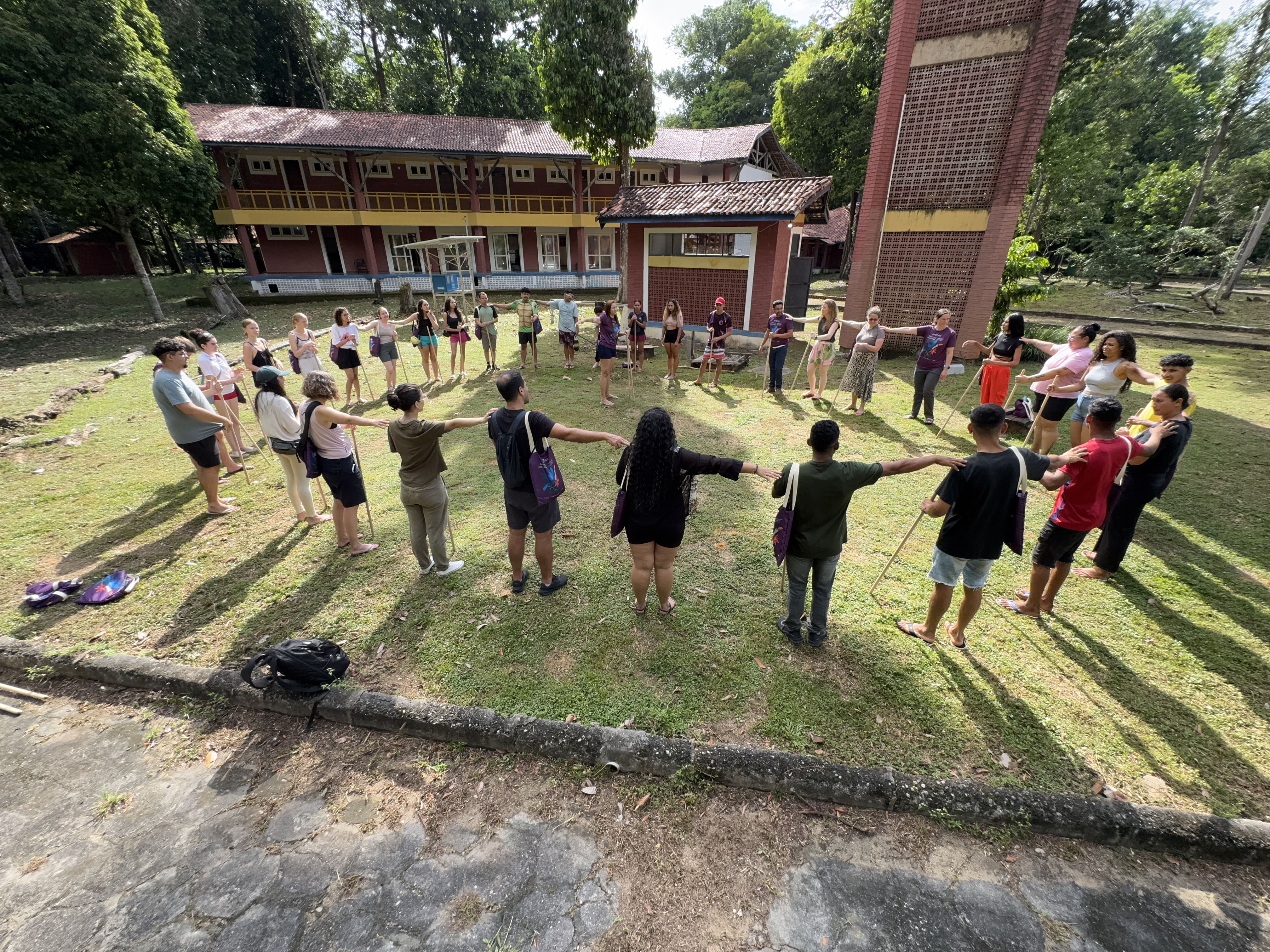 Immerse students and staff standing in a circle playing a game