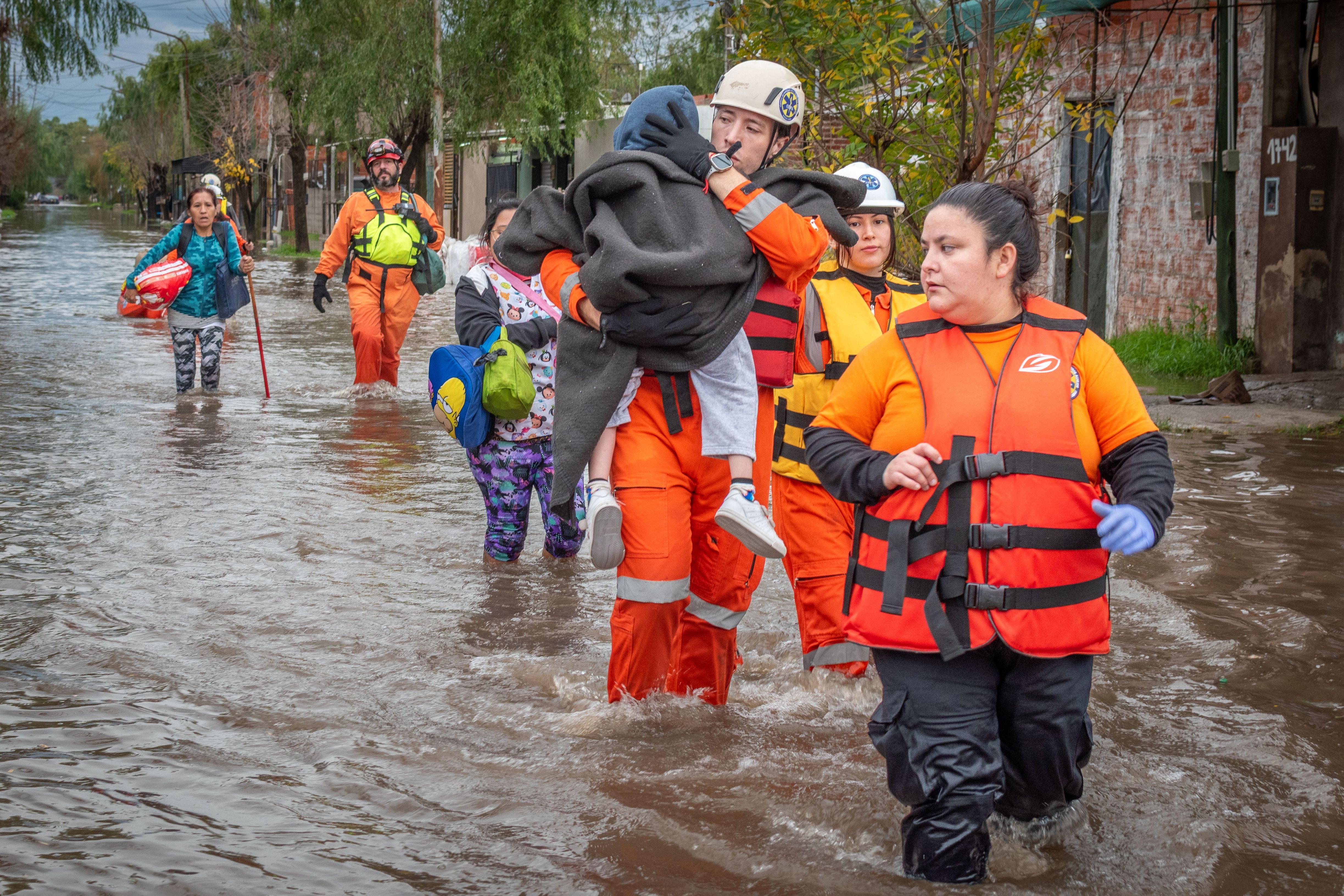 Rescue workers helping people during a flood