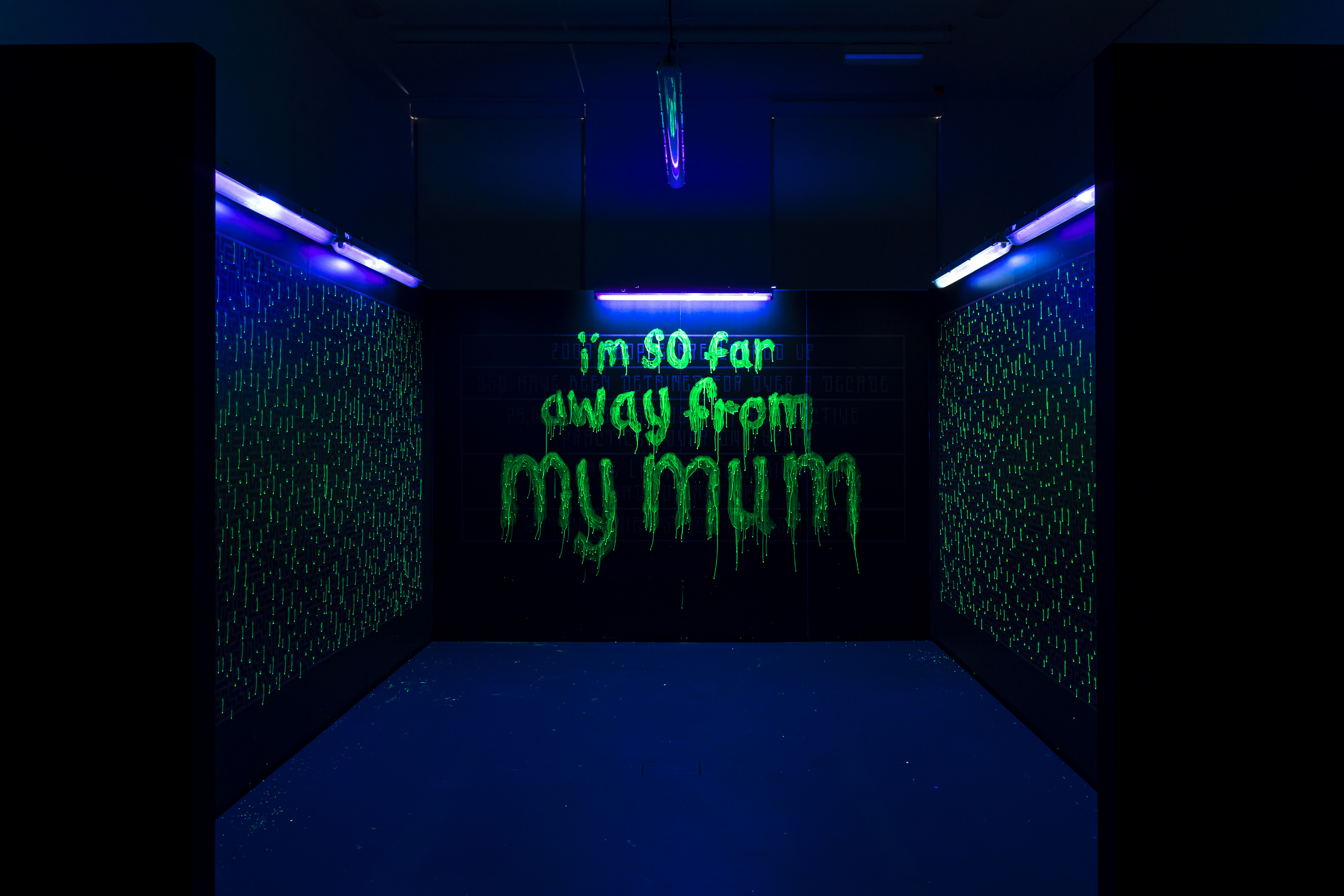 Why are we stuck in hospital? Art exhibition image by Foka Wolf. Writing on a wall says 'I'm so far away from my mum'