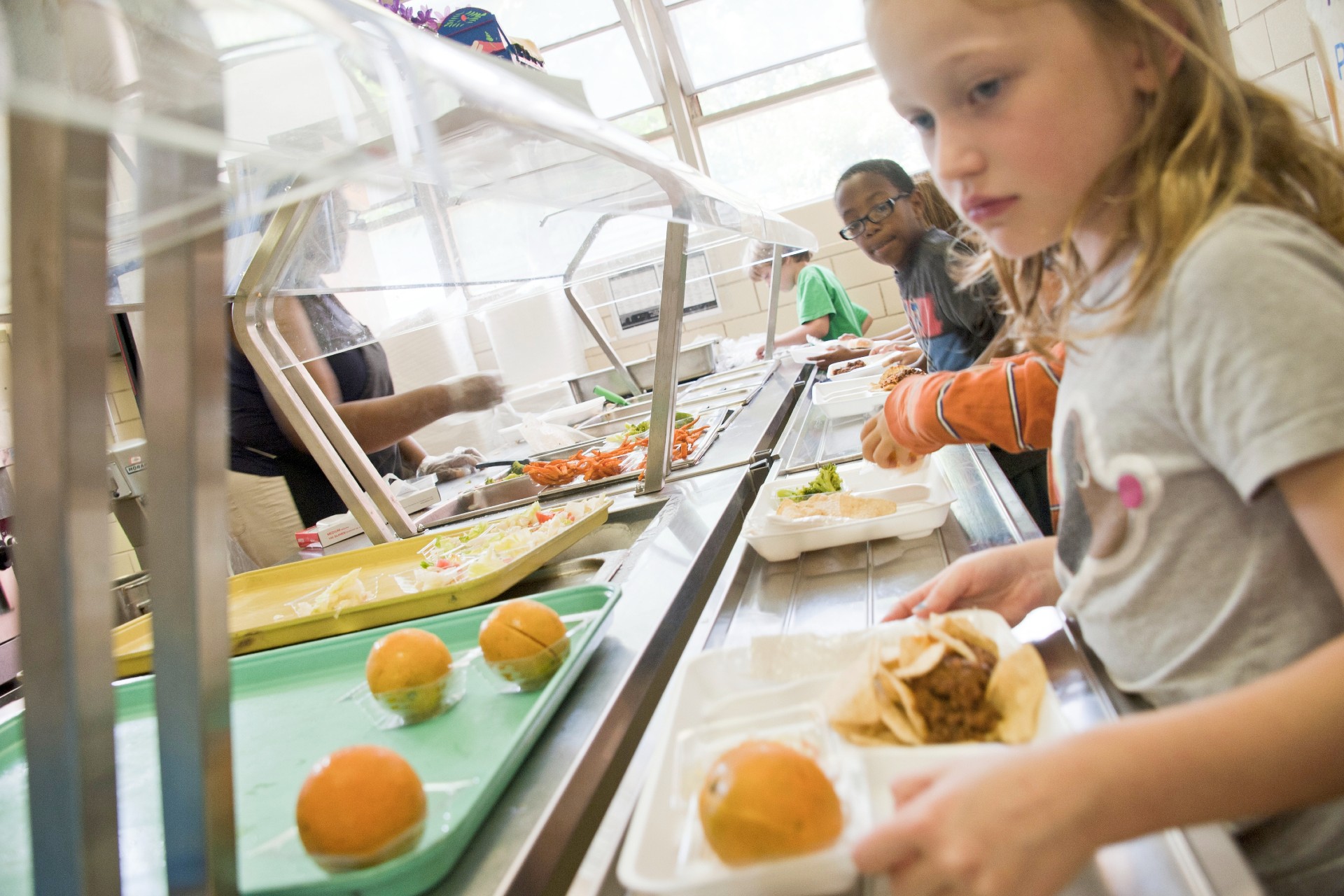 Children getting school meals in a canteen