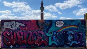 Finished graffiti artwork on University of Birmingham campus, featuring 'Silence' and 'Listen' in large letters.