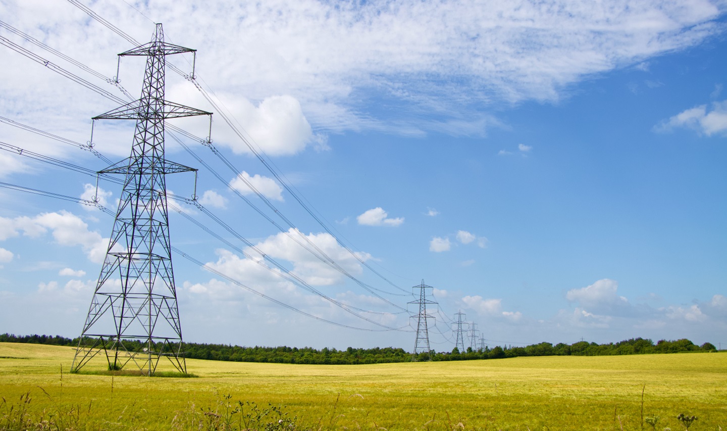 Power lines and pylons in a field