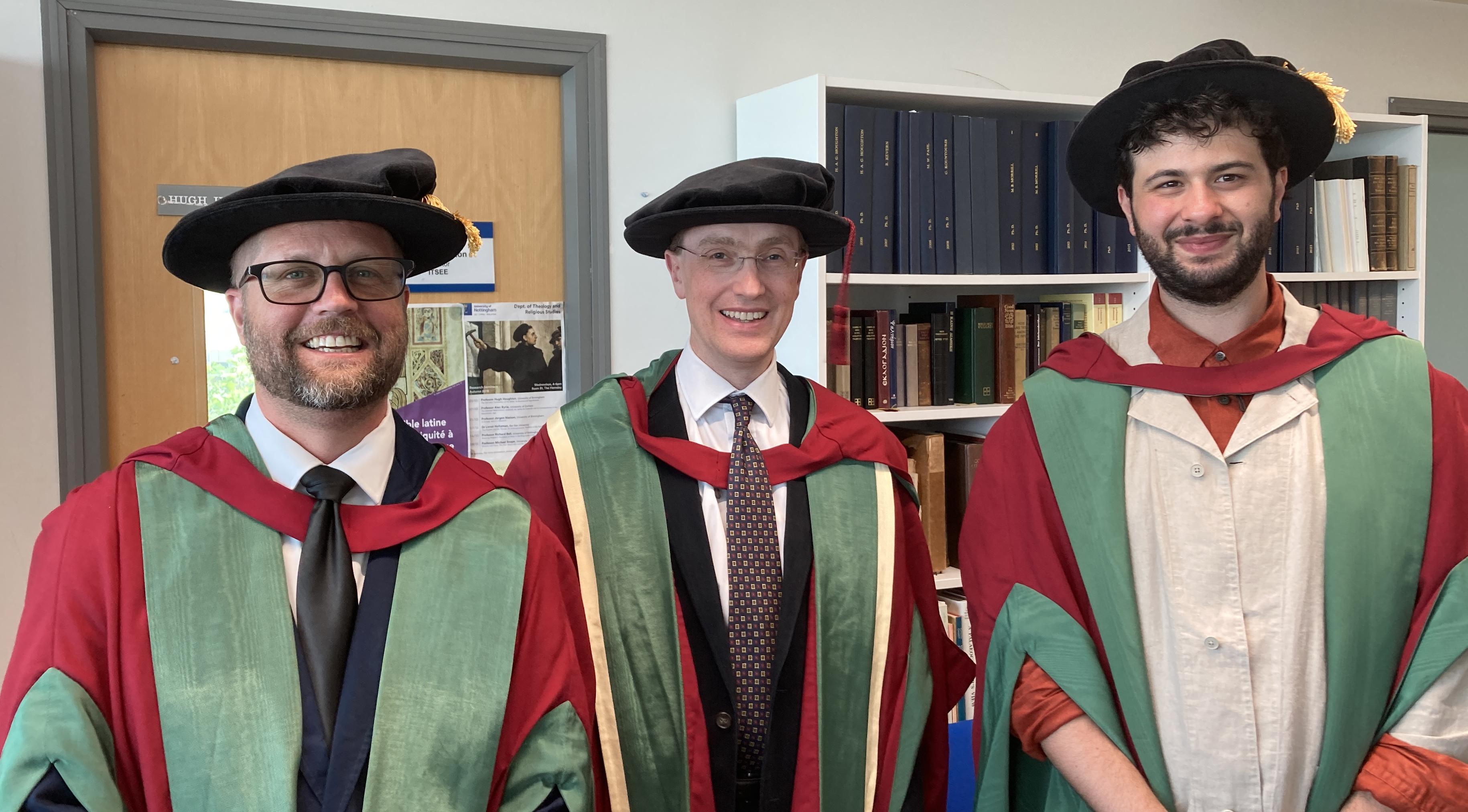 Three people in academic gowns