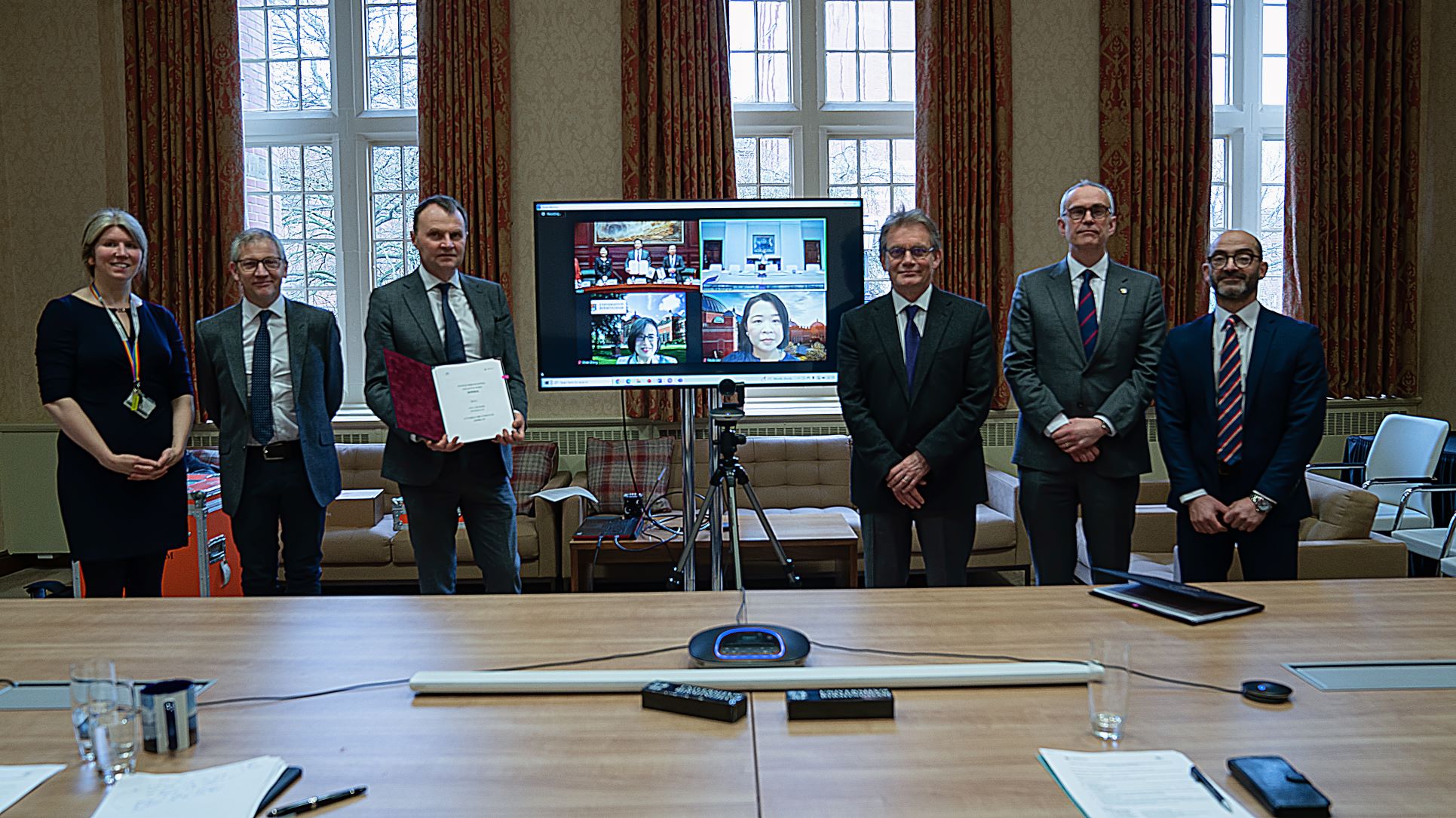 Group of people standing in front of TV screen