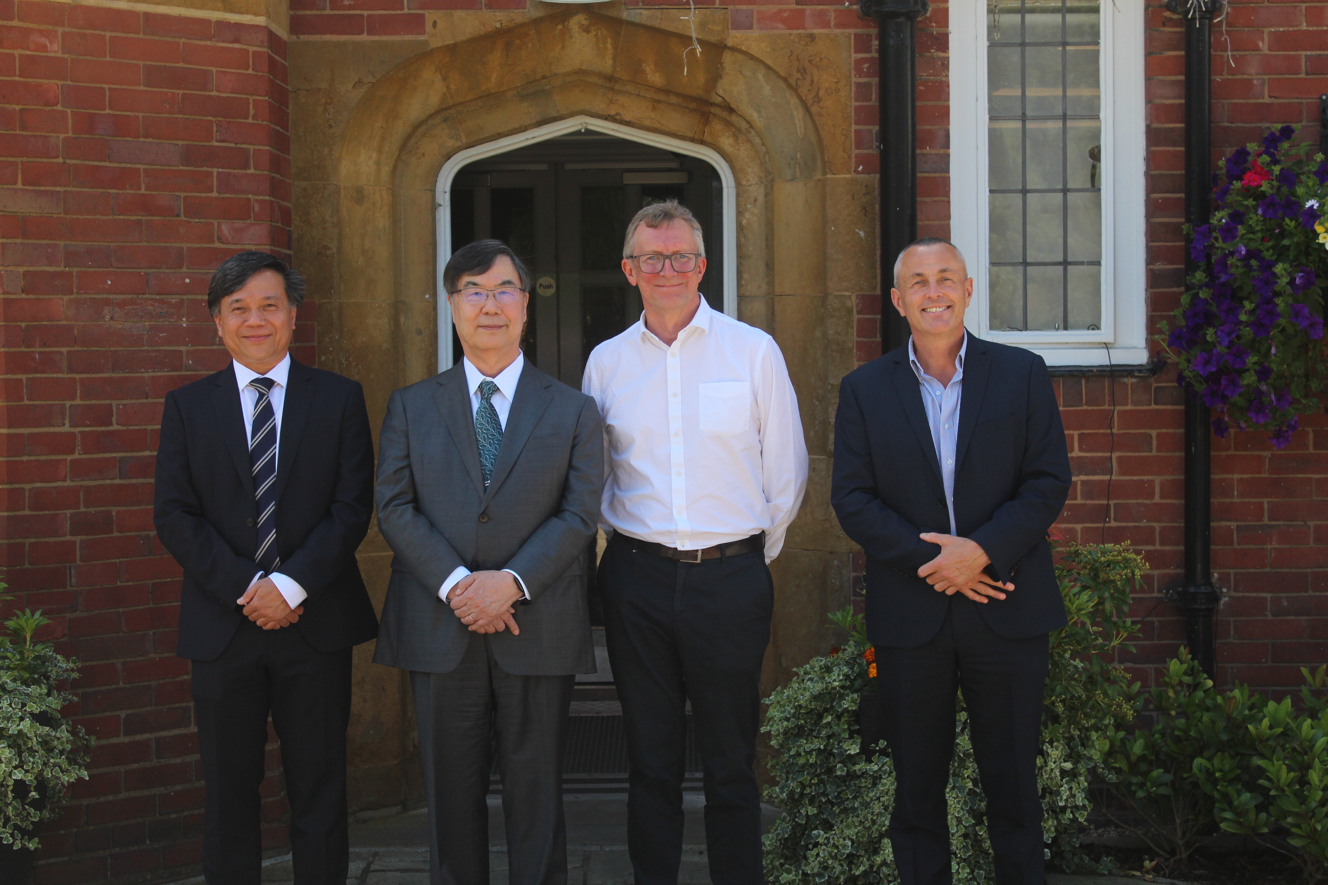 Professor Shimon Sakaguchi stands with University of Birmingham colleagues