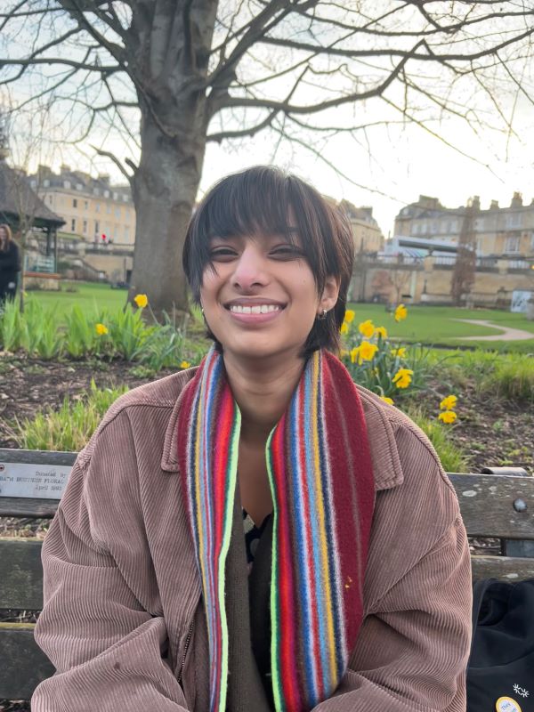 Ira Kalra, MBChB Medicine and Surgery student smiling outside in a park