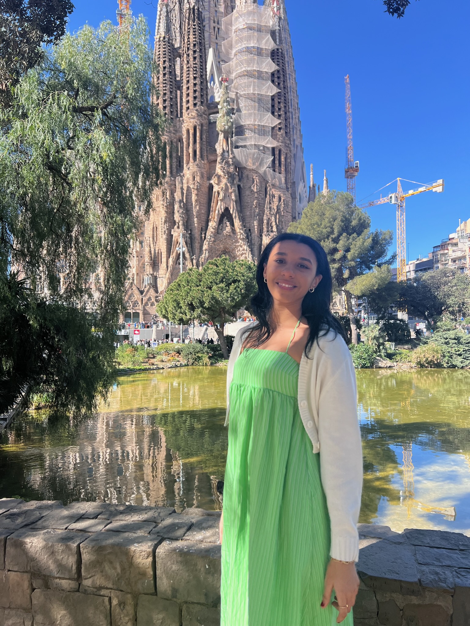 Woman stood infront of the famous church, La Sagrada Familia, in Barcelona.