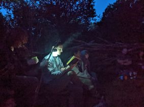 Professor John Holmes reading by night in the Dragon's Nest