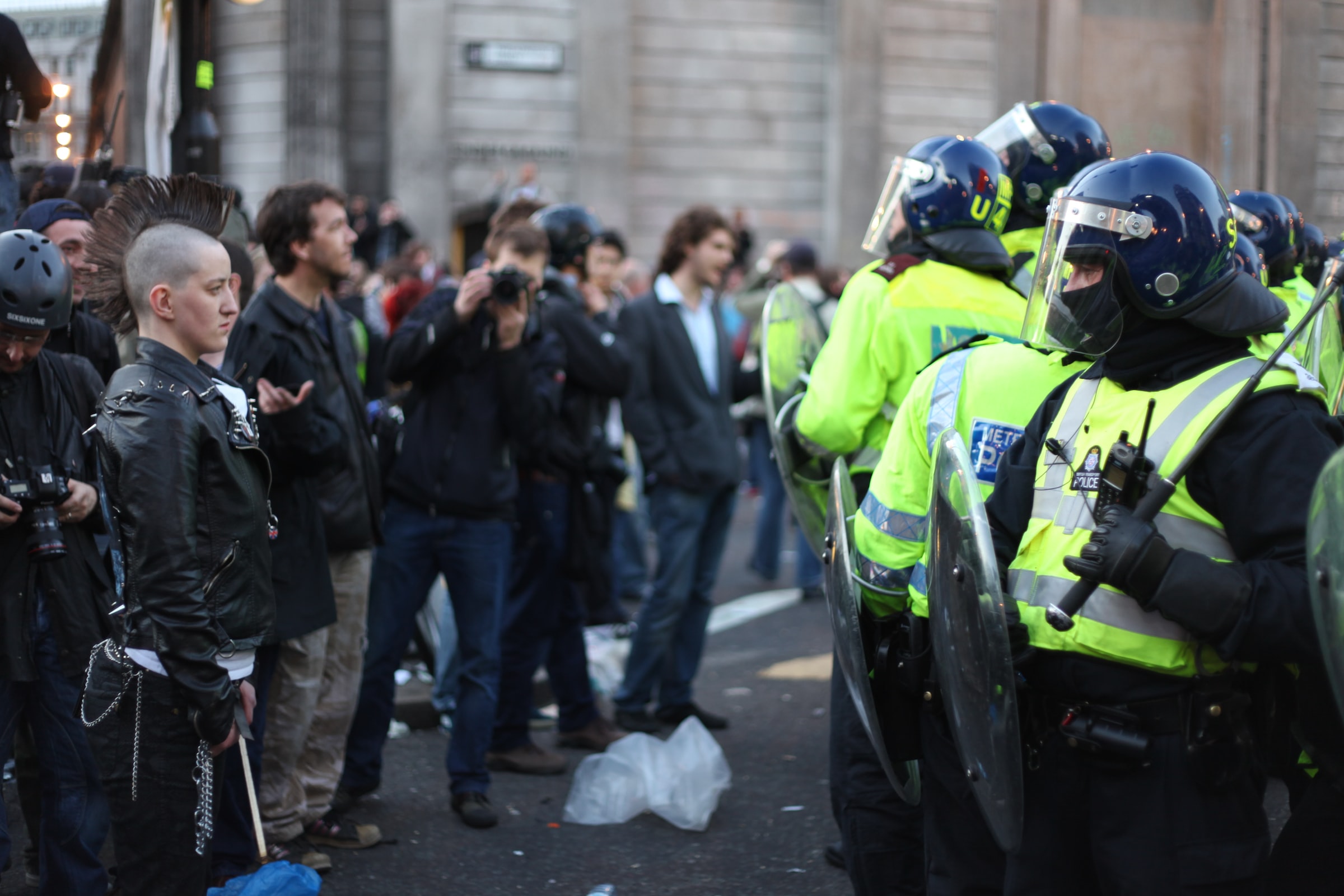 Police in riot gear facing demonstrators