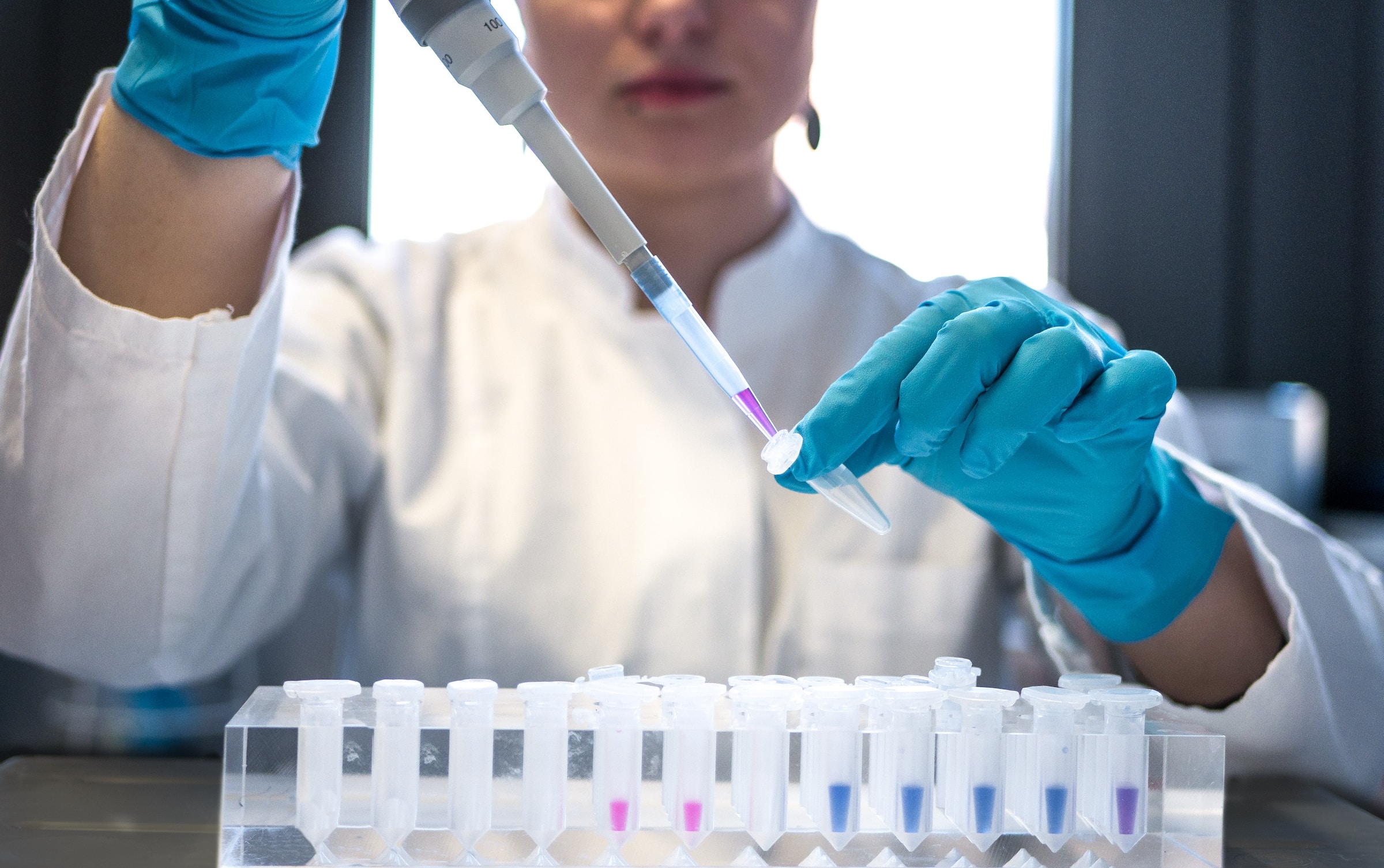 Researcher using pipette in a lab