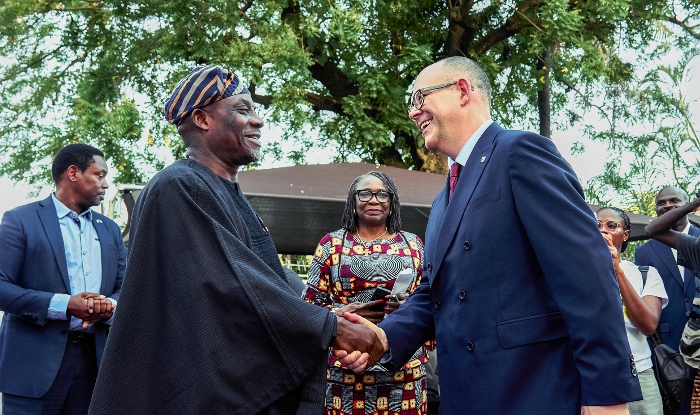 Dr Maruf Tunji Alausa shakes hands with Professor Nick Vaughan-Williams