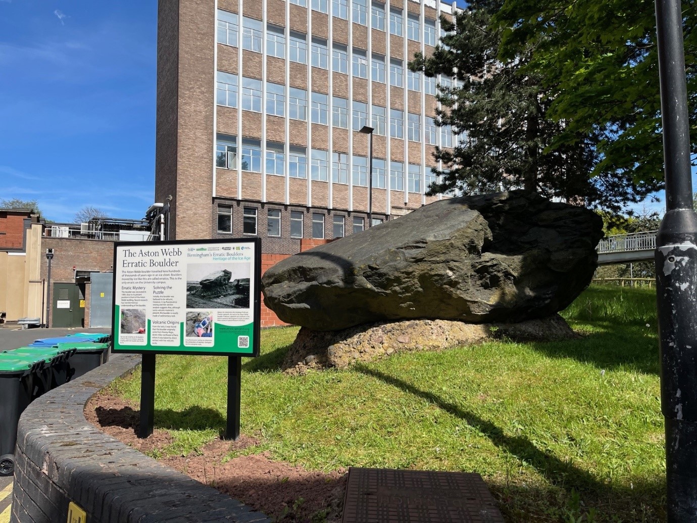 An image of the glacial erratic and new sign on the University campus.