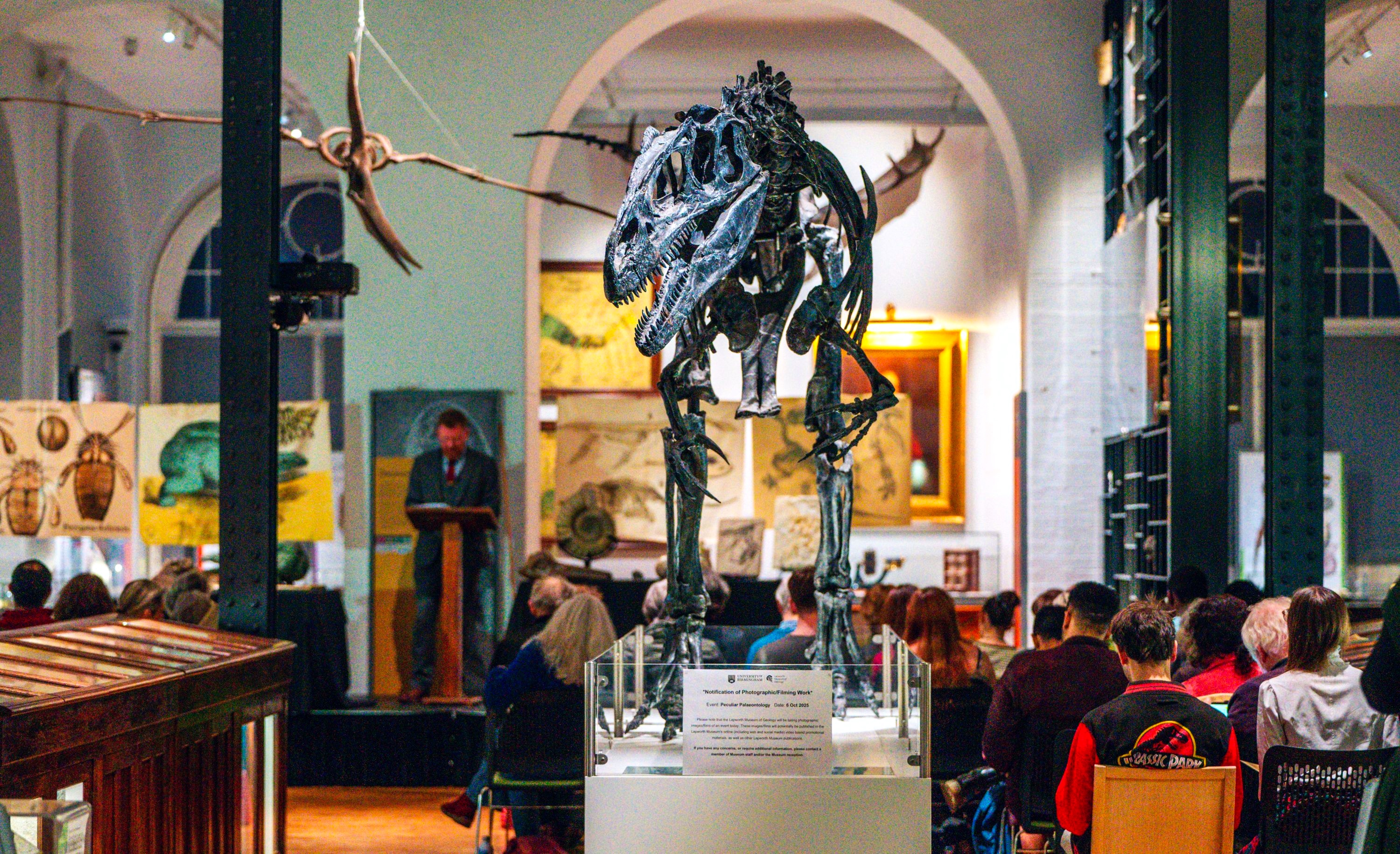 A crowd attend a historical lecture in the Lapworth Museum galleries.