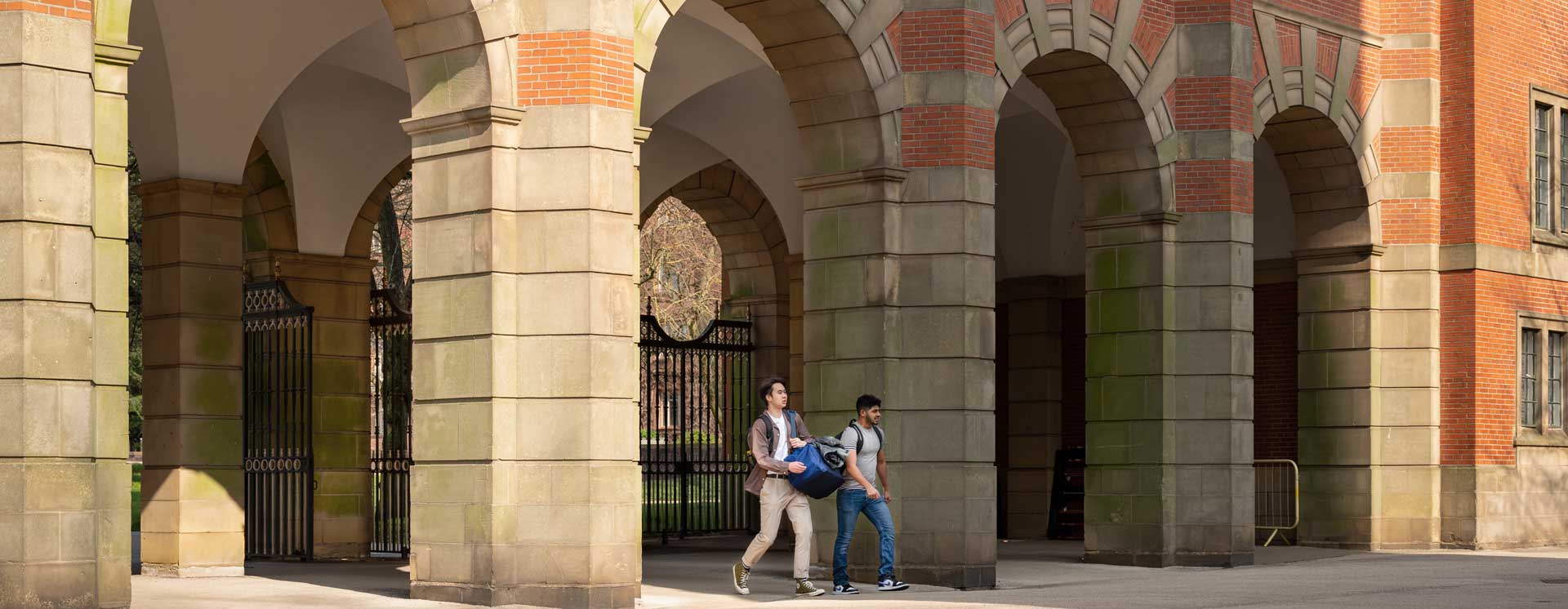 Las Srudents walking under the Birmingham Law School arches