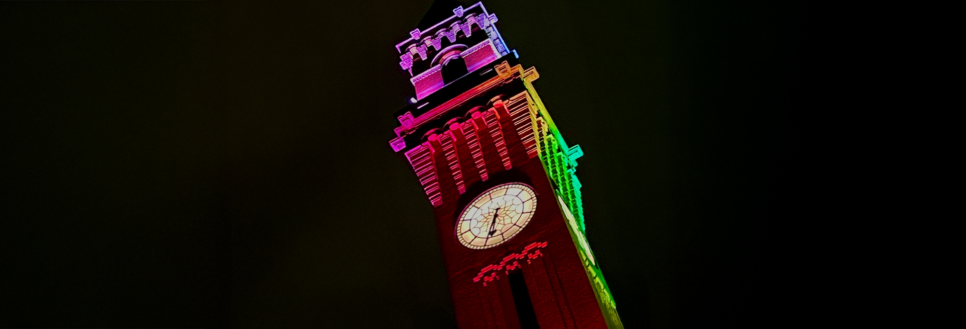 Old Joe clocktower illuminated in rainbow colours at night