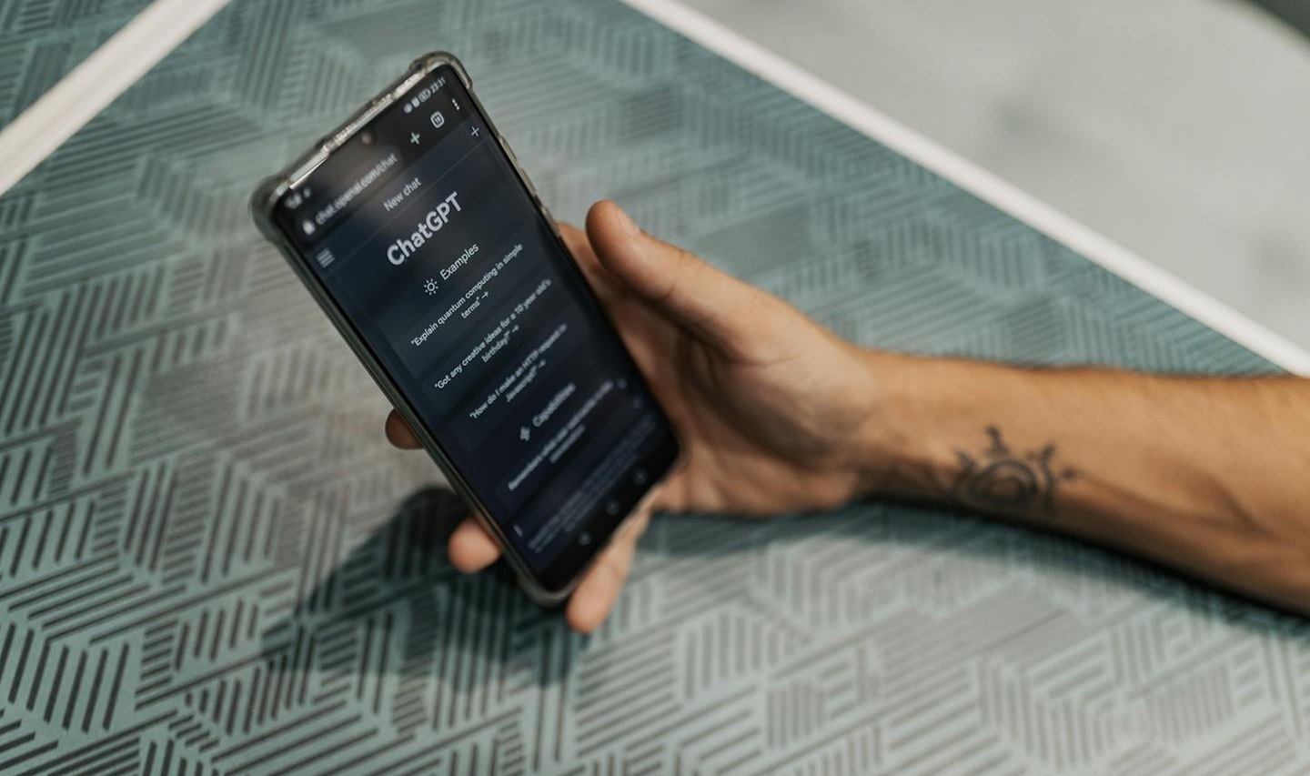 Man holding phone and consulting AI