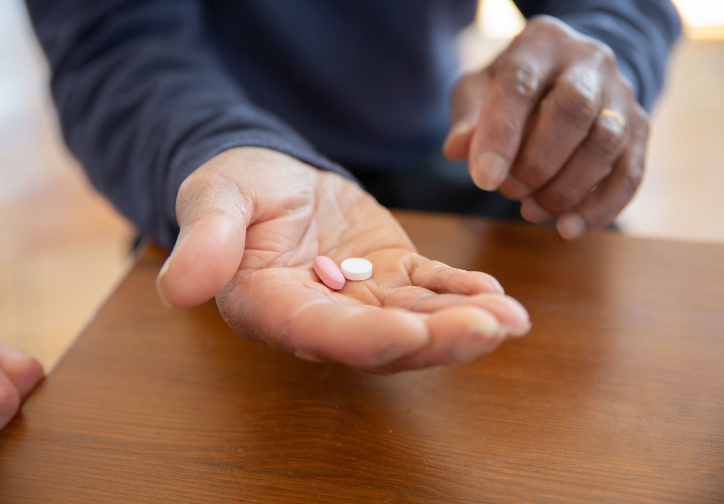 Man holding two tablets in his hand