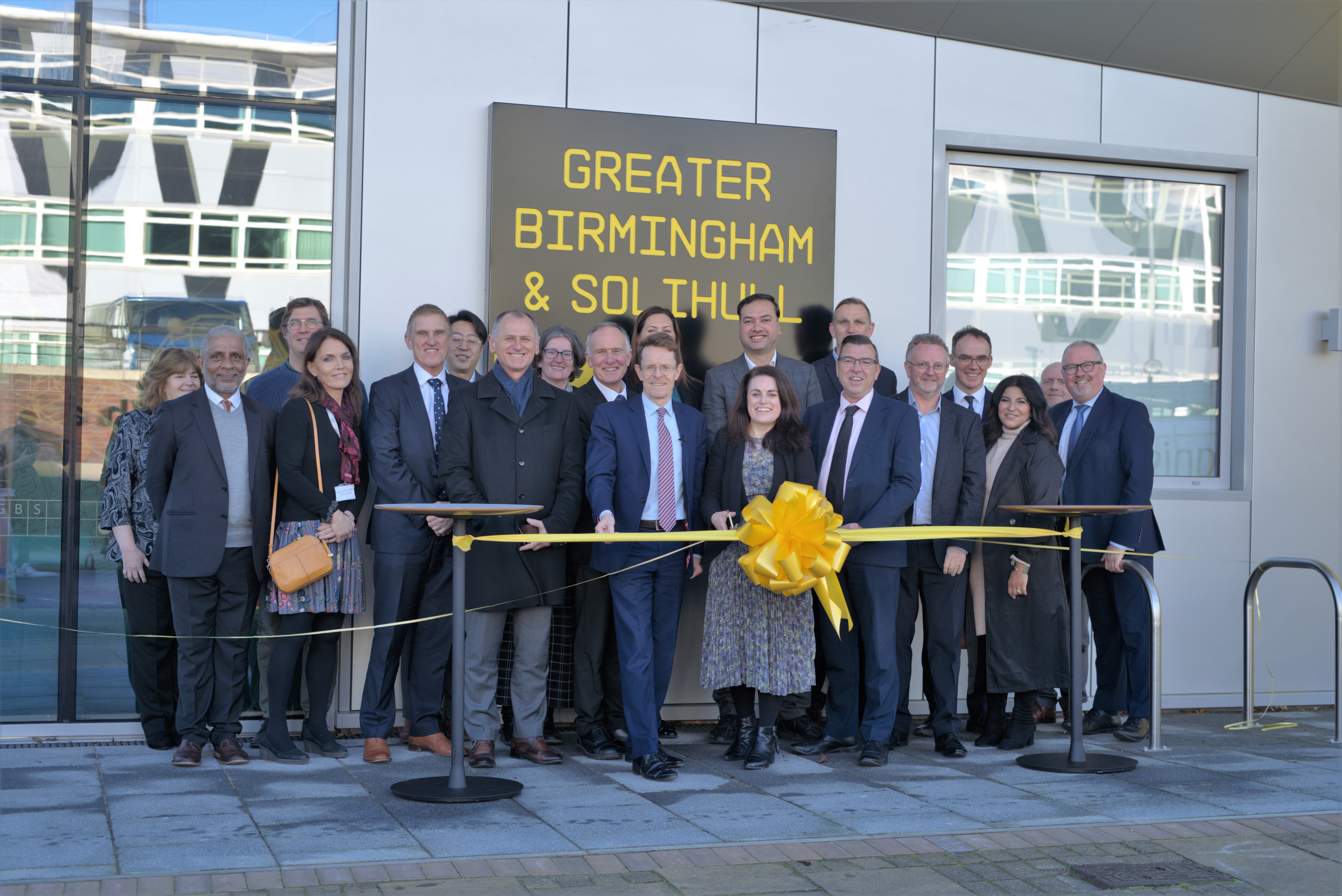 Mayor Andy Street and others cut a yellow ribbon in front of the new building