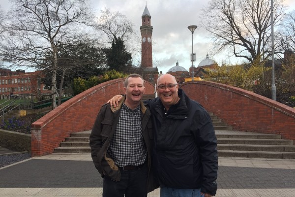 Two men in front of Old Joe clocktower