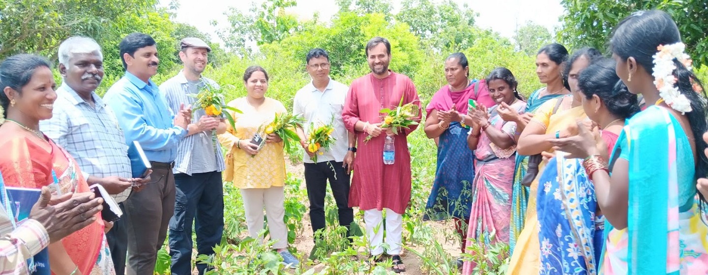 Researchers and farmers standing in a field together