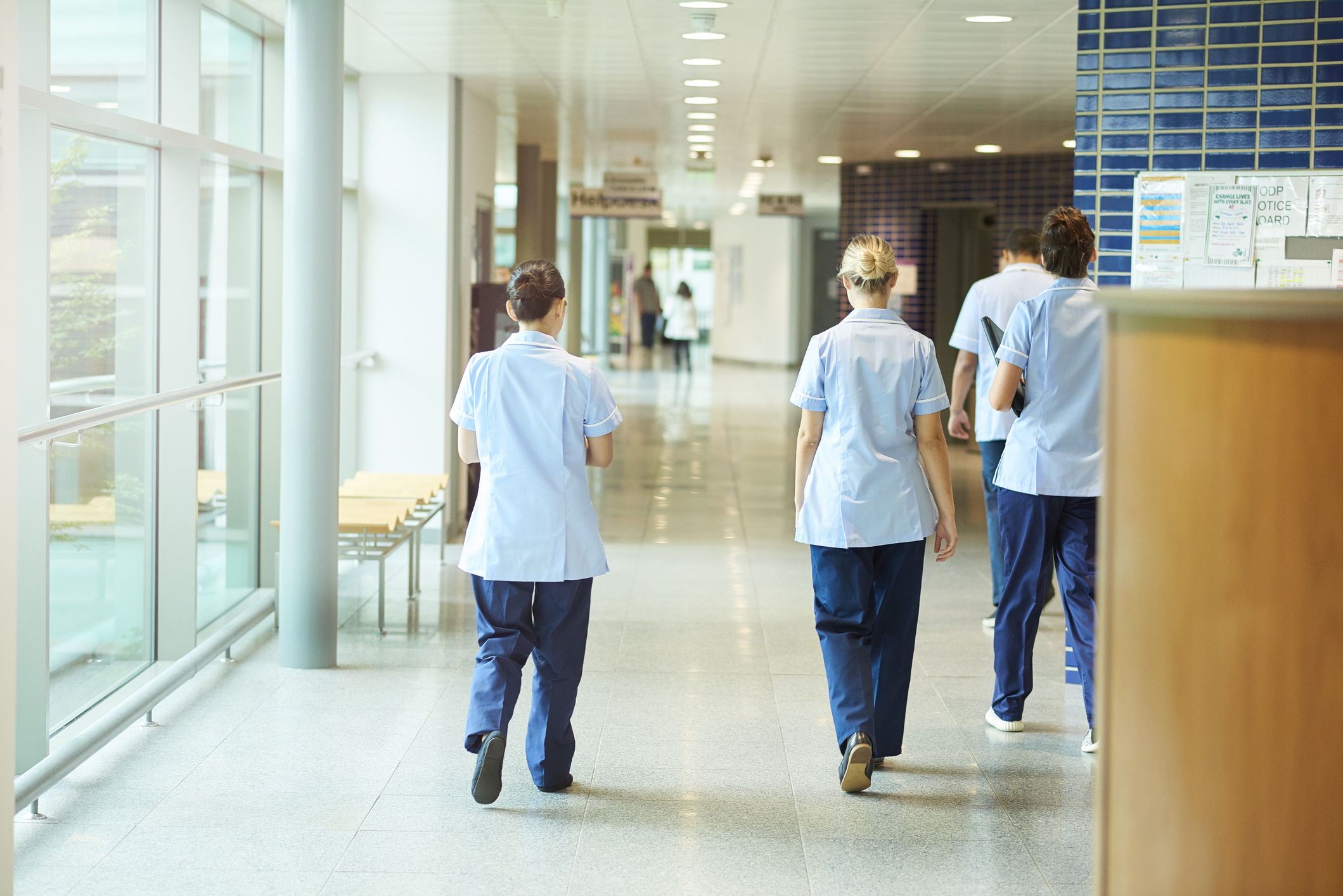 Hospital with medical staff walking down a coridoor 