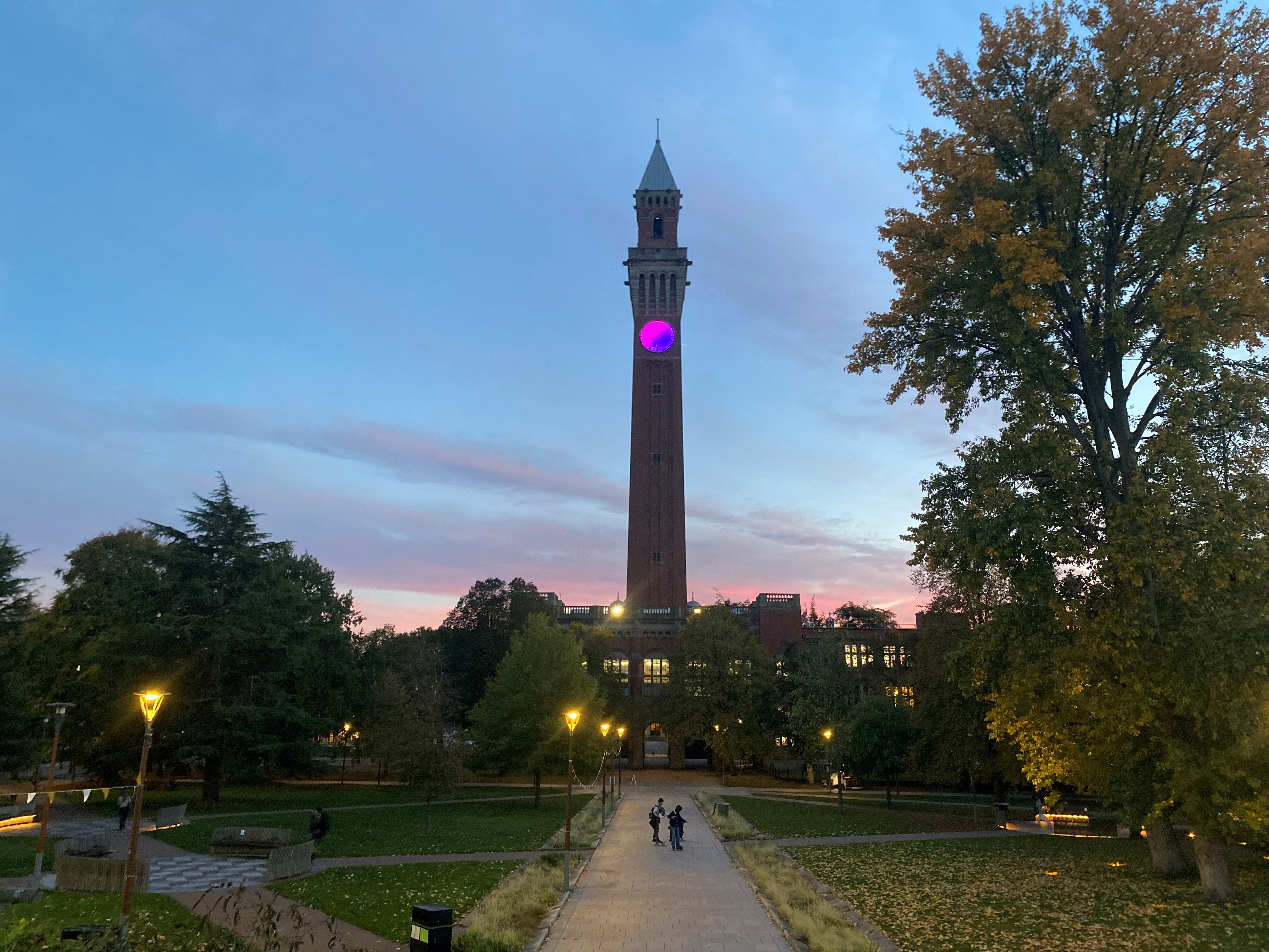 Old Joe clock tower, lit up pink and blue at night