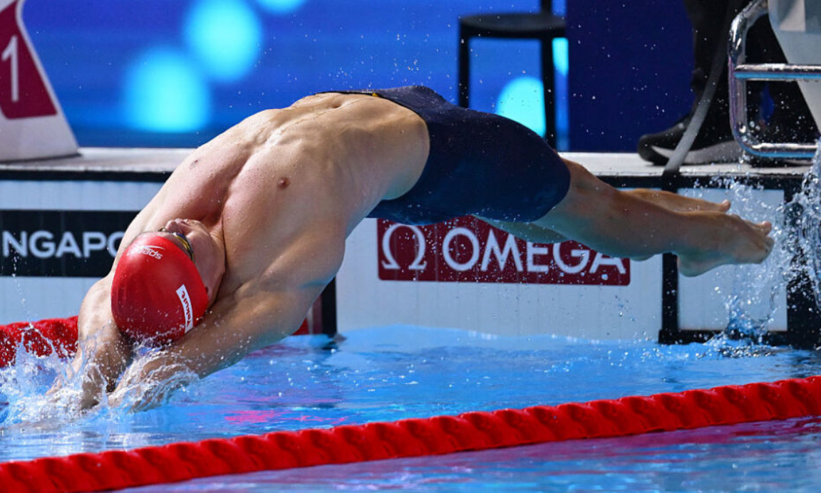 Ollie Morgan performs a backstroke start and leaps into the pool