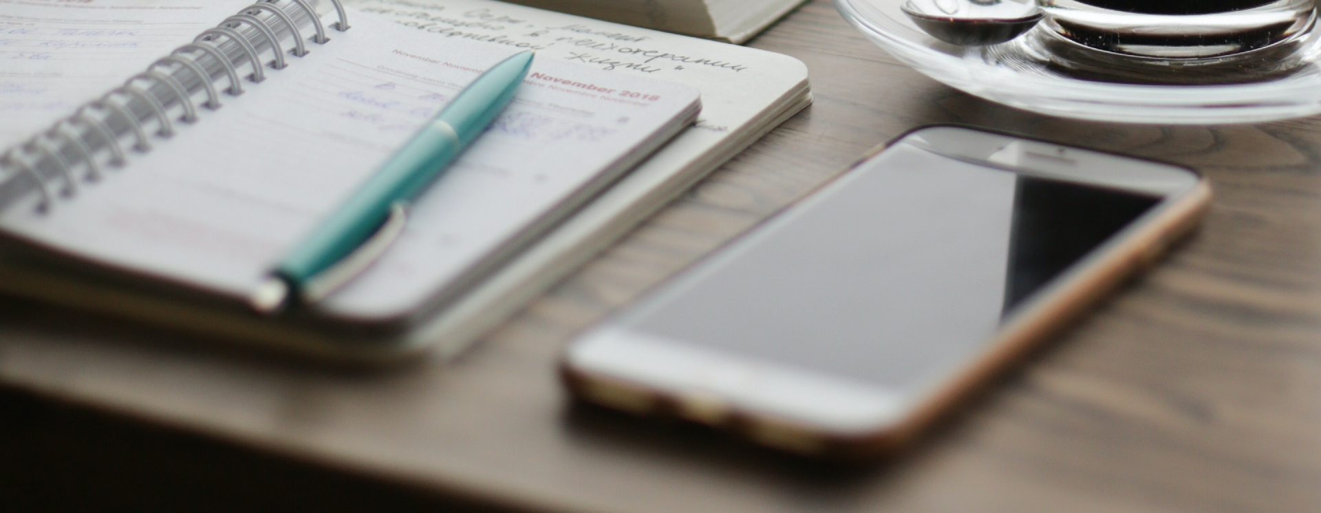 A phone next to an open notebook