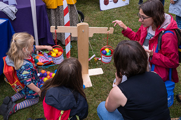 Outreach event where a child is putting balls in a balance
