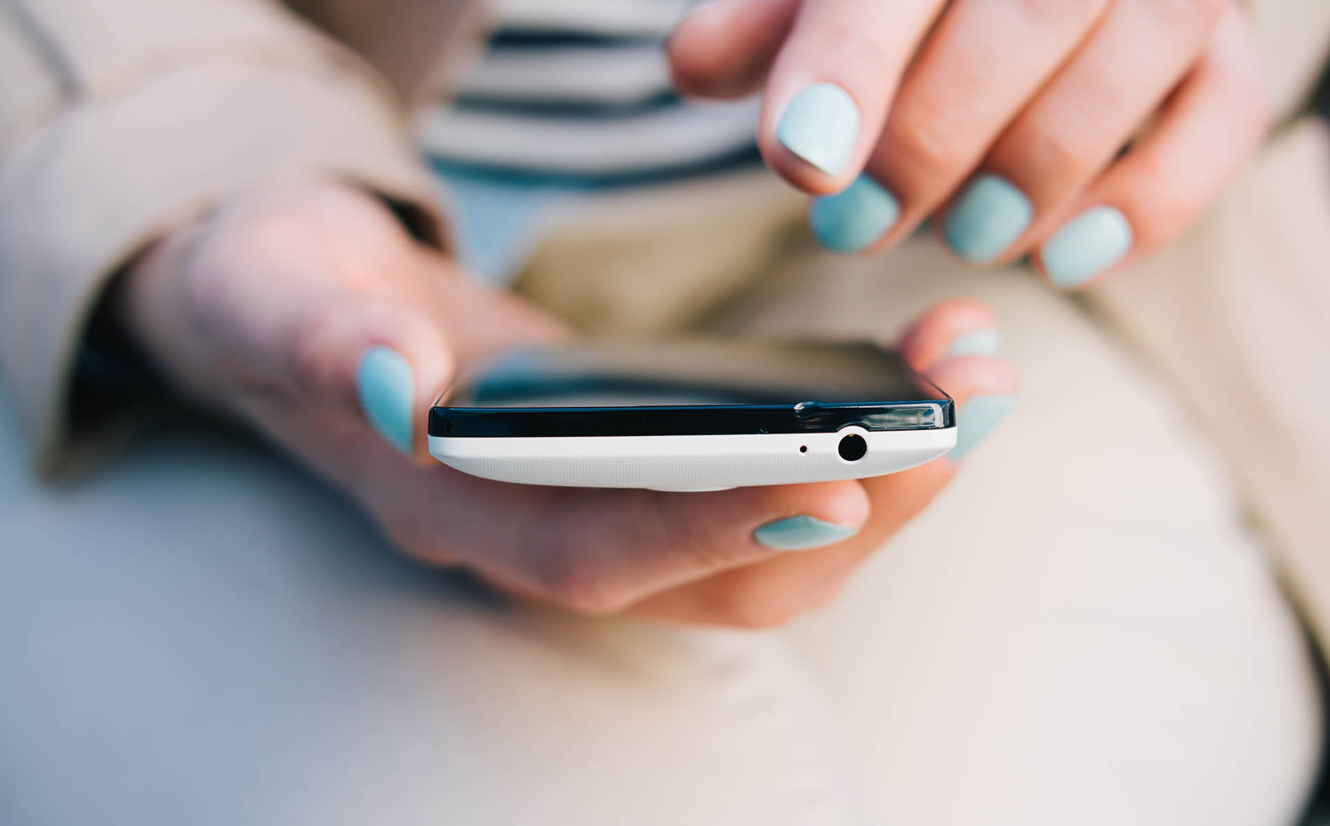 Female hands holding mobile phone