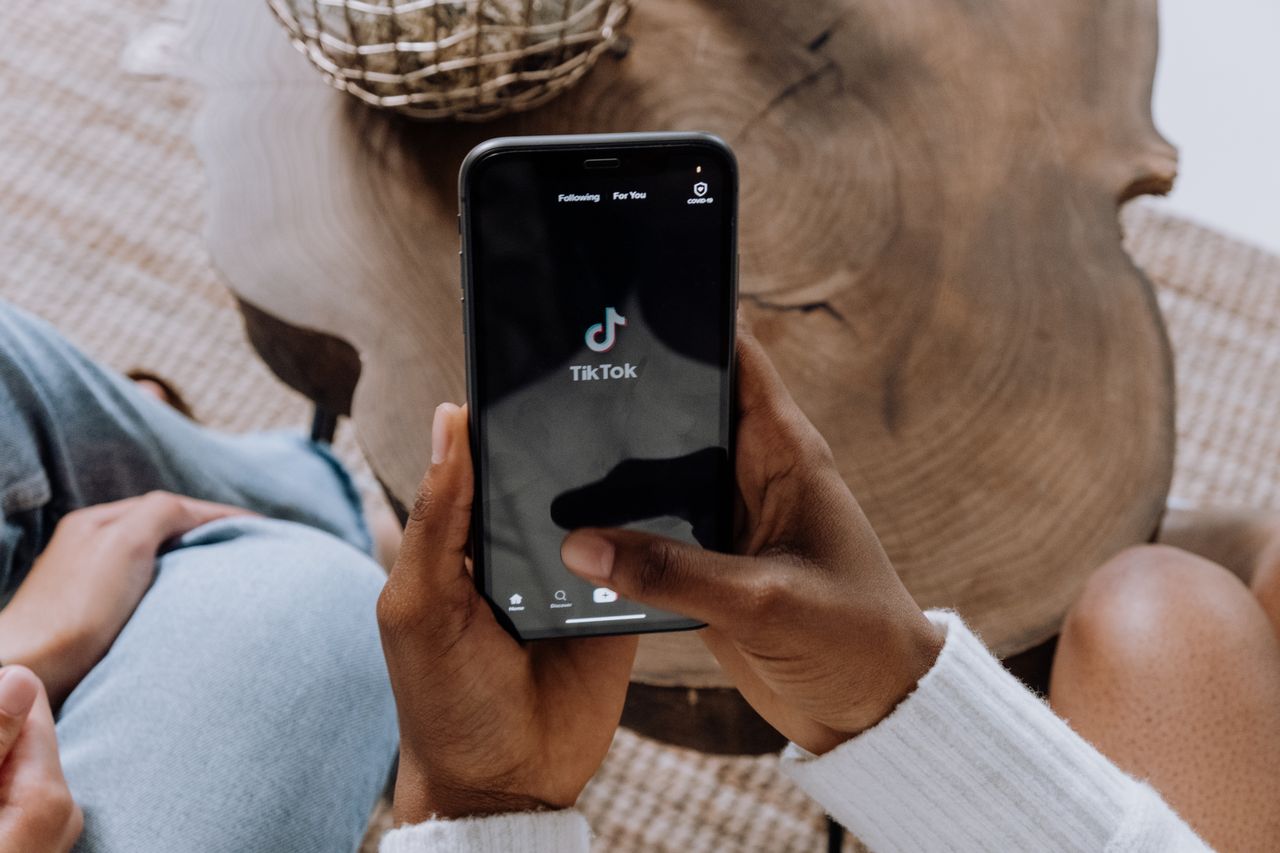 Someone holding a phone looking at TikTok. 
