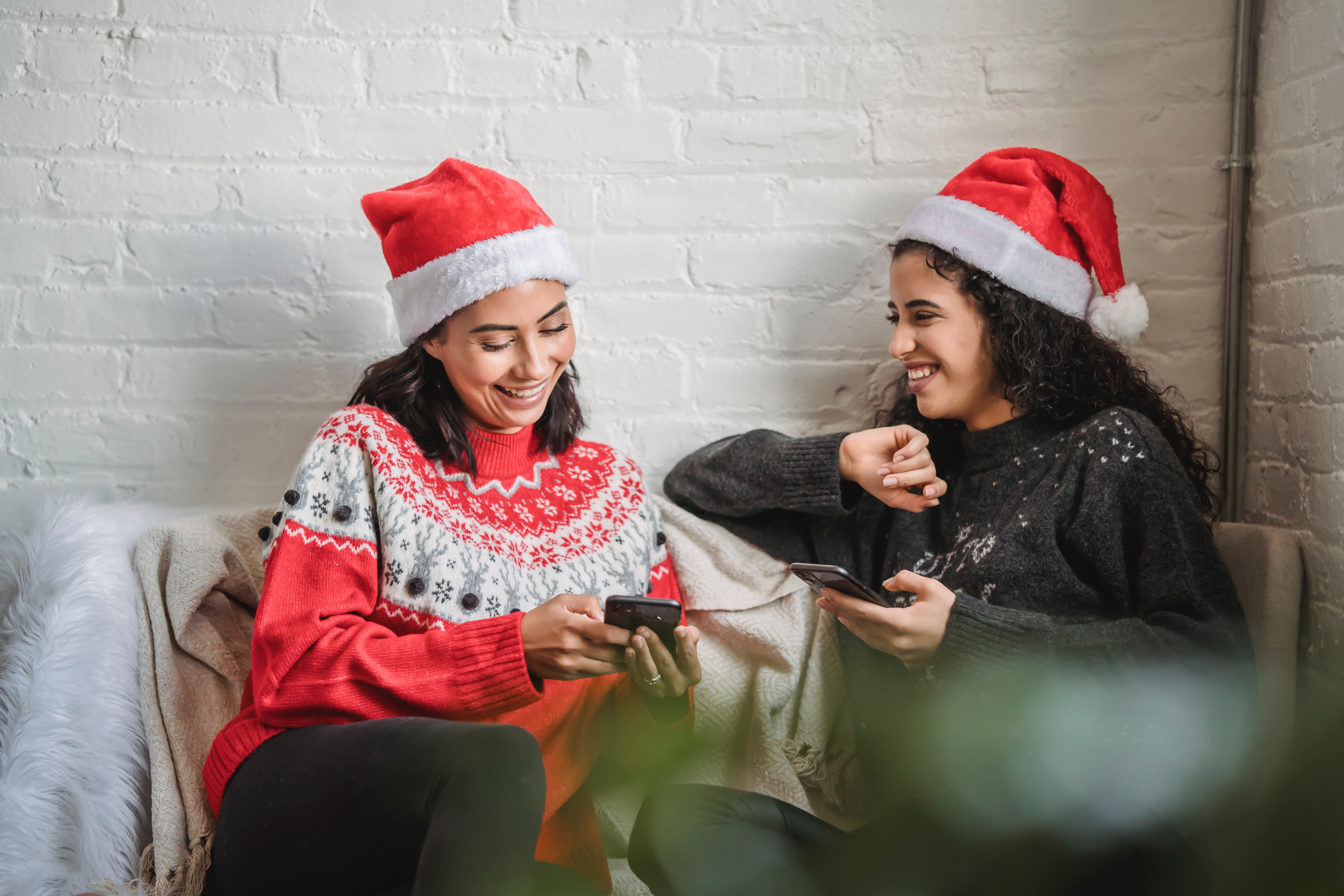 Two women wearing festive outfits and chatting