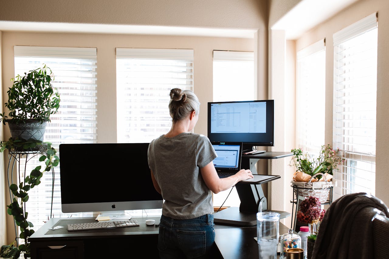 A woman at a standing desk working from home. 