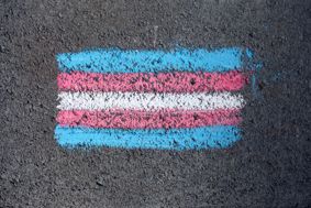  Chalk drawing of the transgender flag on a pavement.