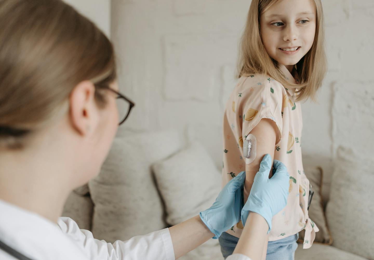 Clinician checking a child with an insulin pump