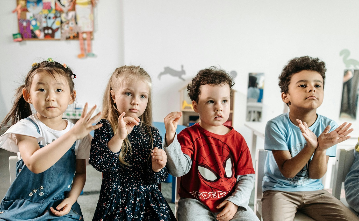 Four children using sign language