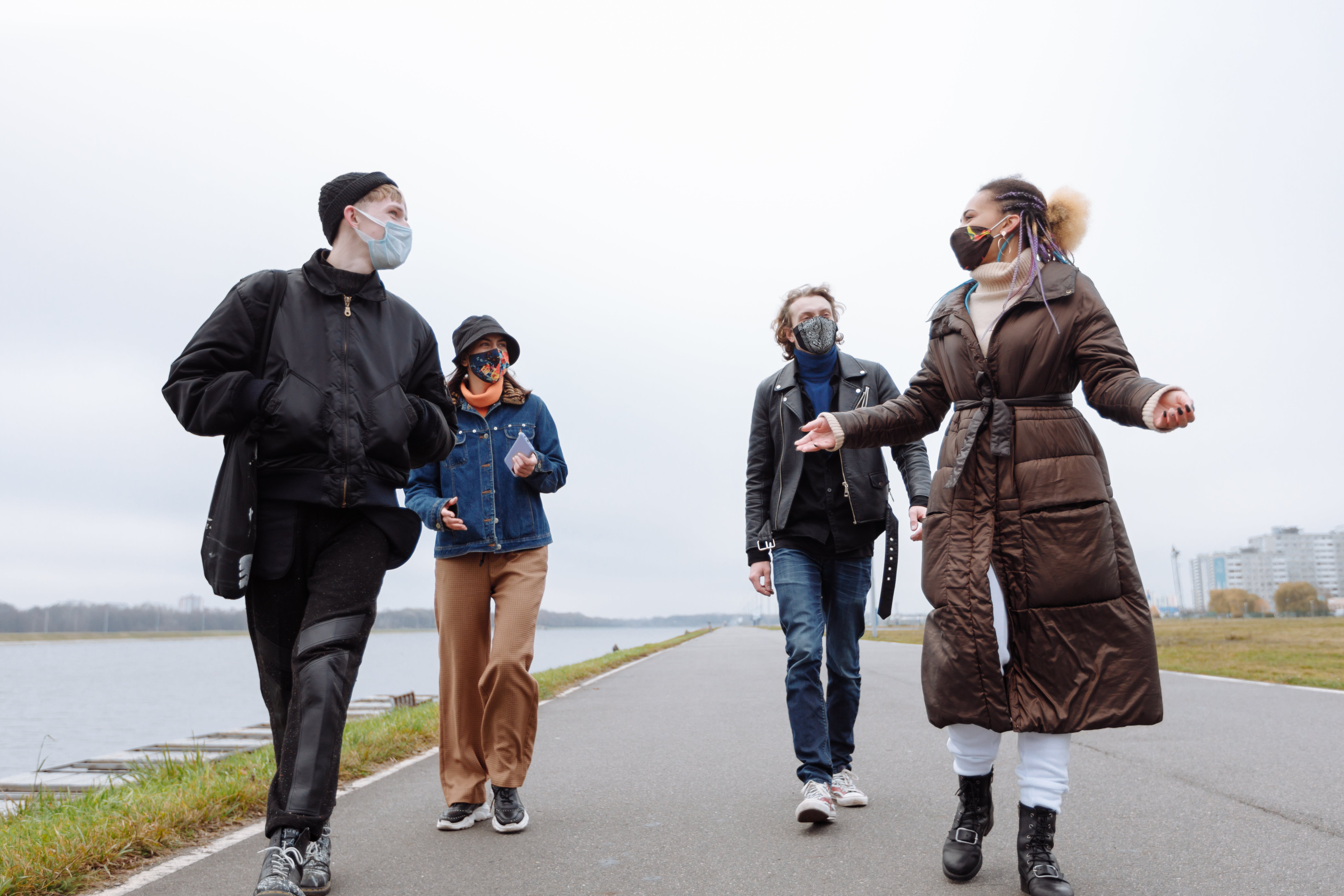 A group of four friends on a socially distanced walk whilst wearing masks