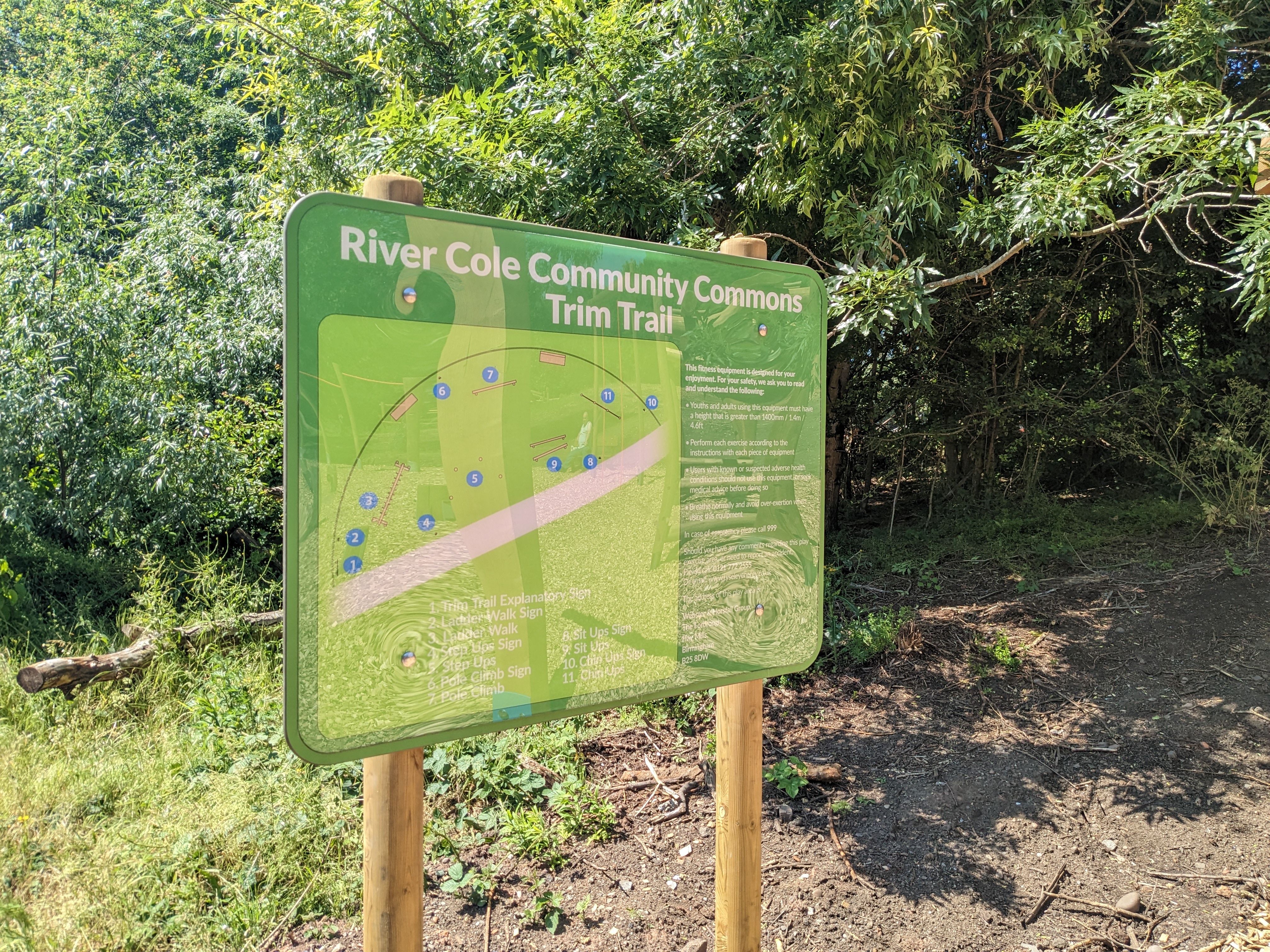 A sign shows the River Cole Community Commons Trim Trail 