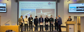 Birmingham aerospace students accepting aprestigious international light aircraft design competition prize on stage