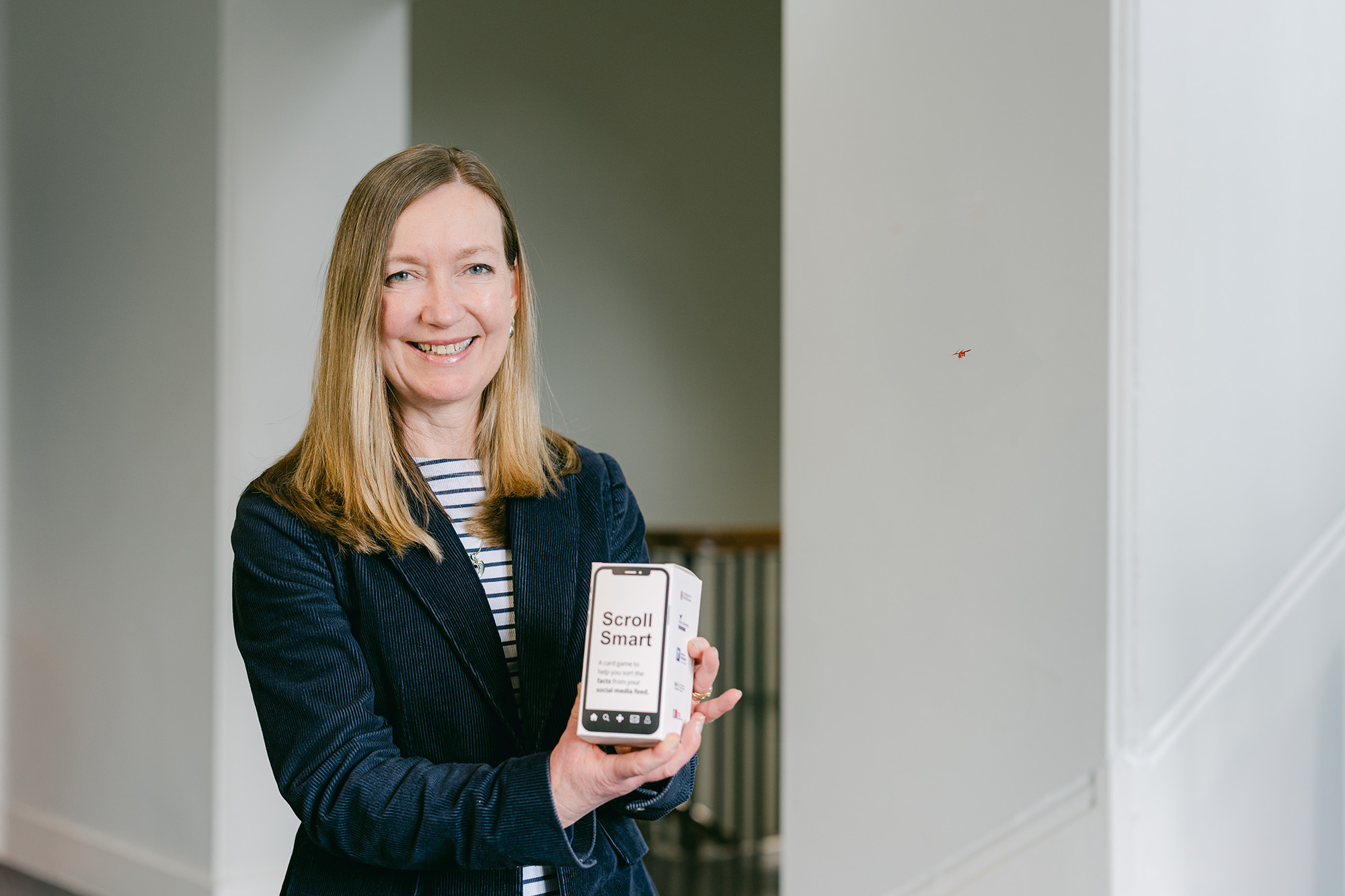 Professor Ruth Page poses with the Scroll Smart card game
