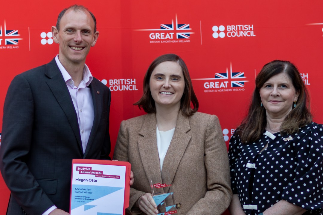 Three smartly dressed people holding awards